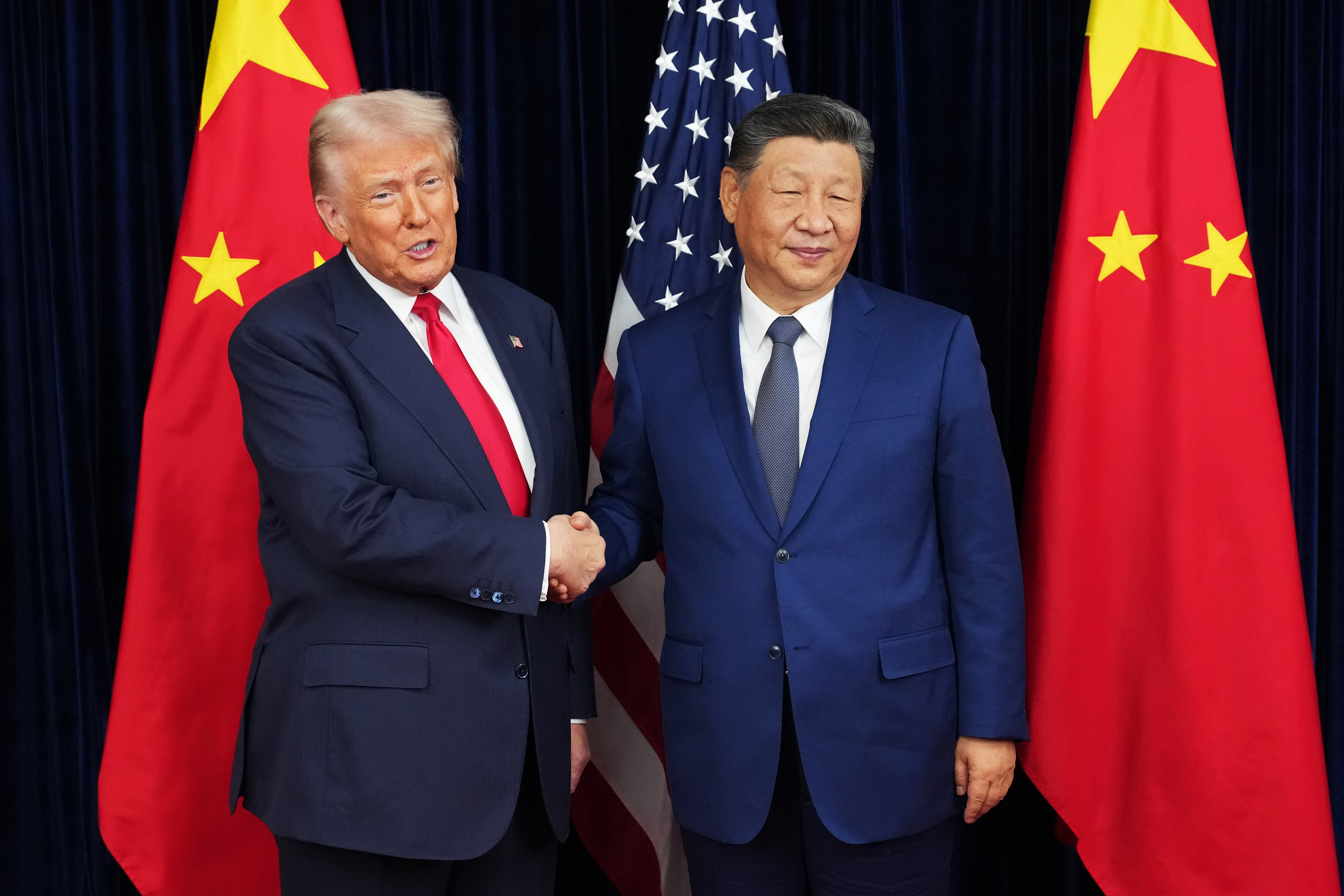 US President Donald Trump greets Chinese President Xi Jinping.