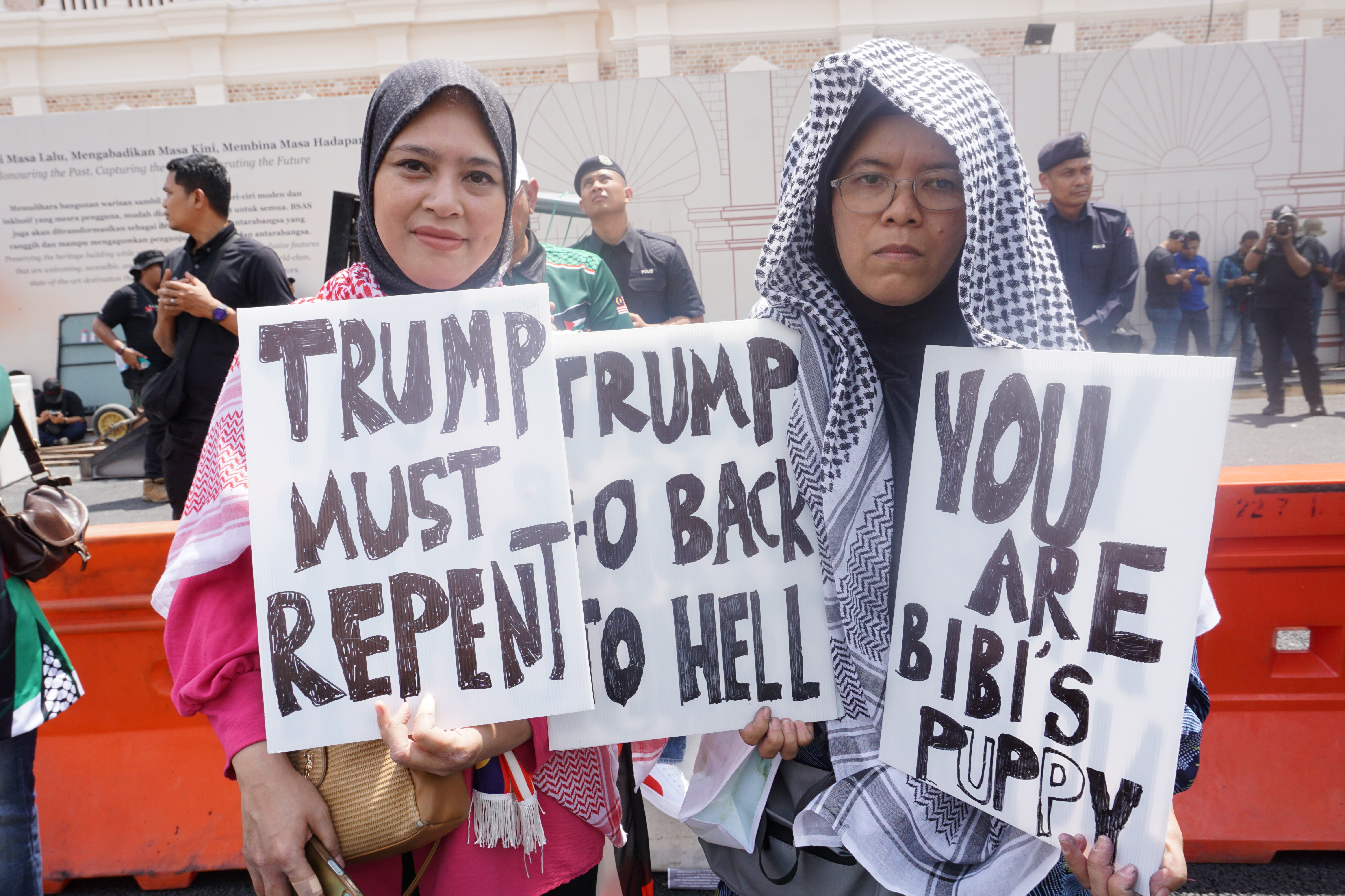 Asma Hanim Mahoud (left) travelled several hundred kilmetres to attend a demonstration against US President Donald Trump in Kuala Lumpur on October 26, 2025. [Erin Hale/ Al Jazeera]
