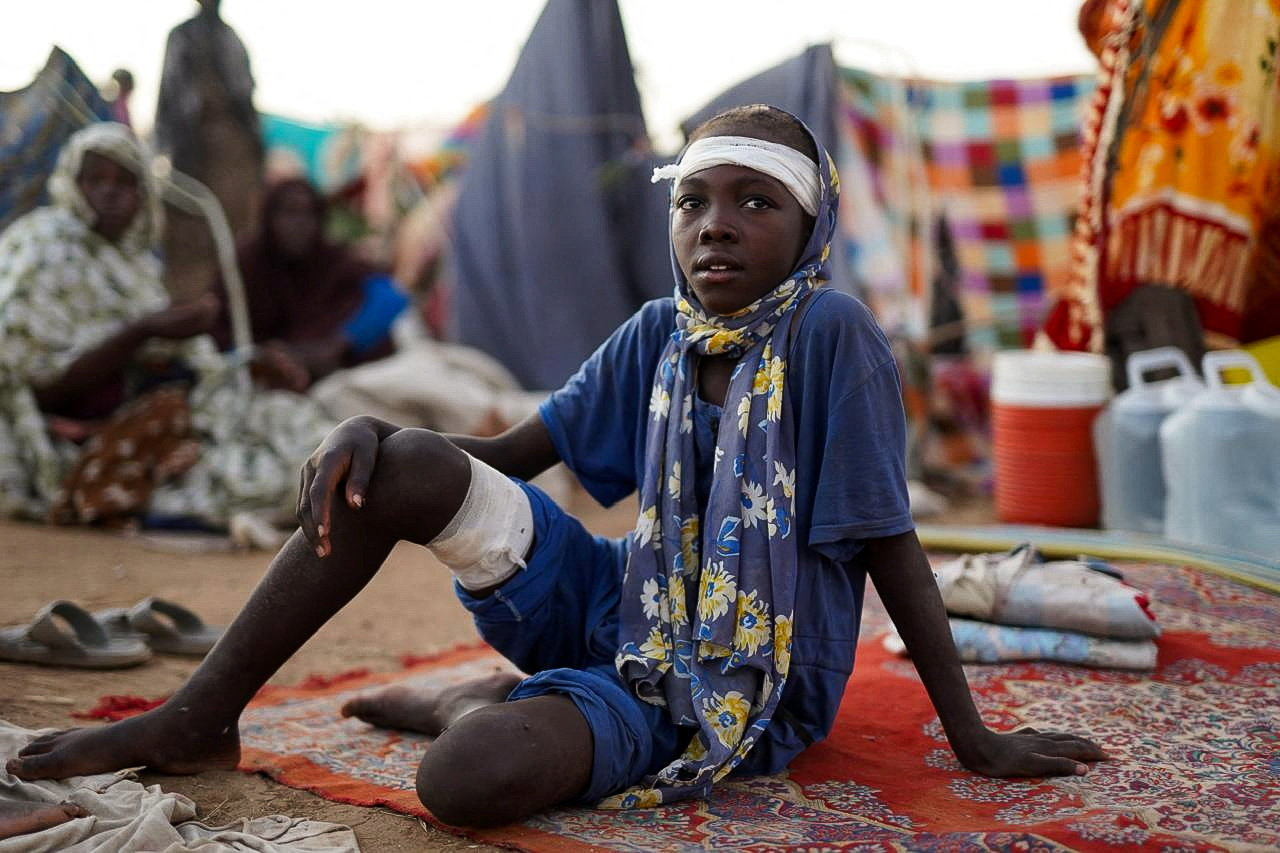 A grandchild of Ikram Abdelhameed looks on while sitting at a camp for displaced people who fled from al-Fashir to Tawila, North Darfur, Sudan, October 27, 2025. REUTERS/Mohammed Jamal