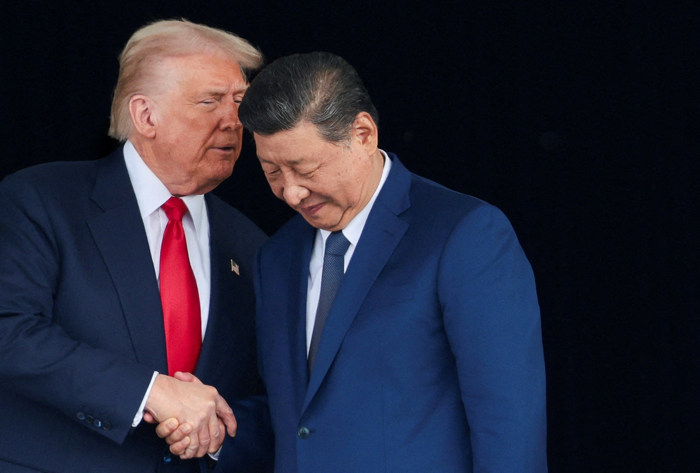 U.S. President Donald Trump and Chinese President Xi Jinping talk as they leave after a bilateral meeting at Gimhae International Airport, on the sidelines of the Asia-Pacific Economic Cooperation (APEC) summit, in Busan, South Korea, October 30, 2025. REUTERS/Evelyn Hockstein TPX IMAGES OF THE DAY