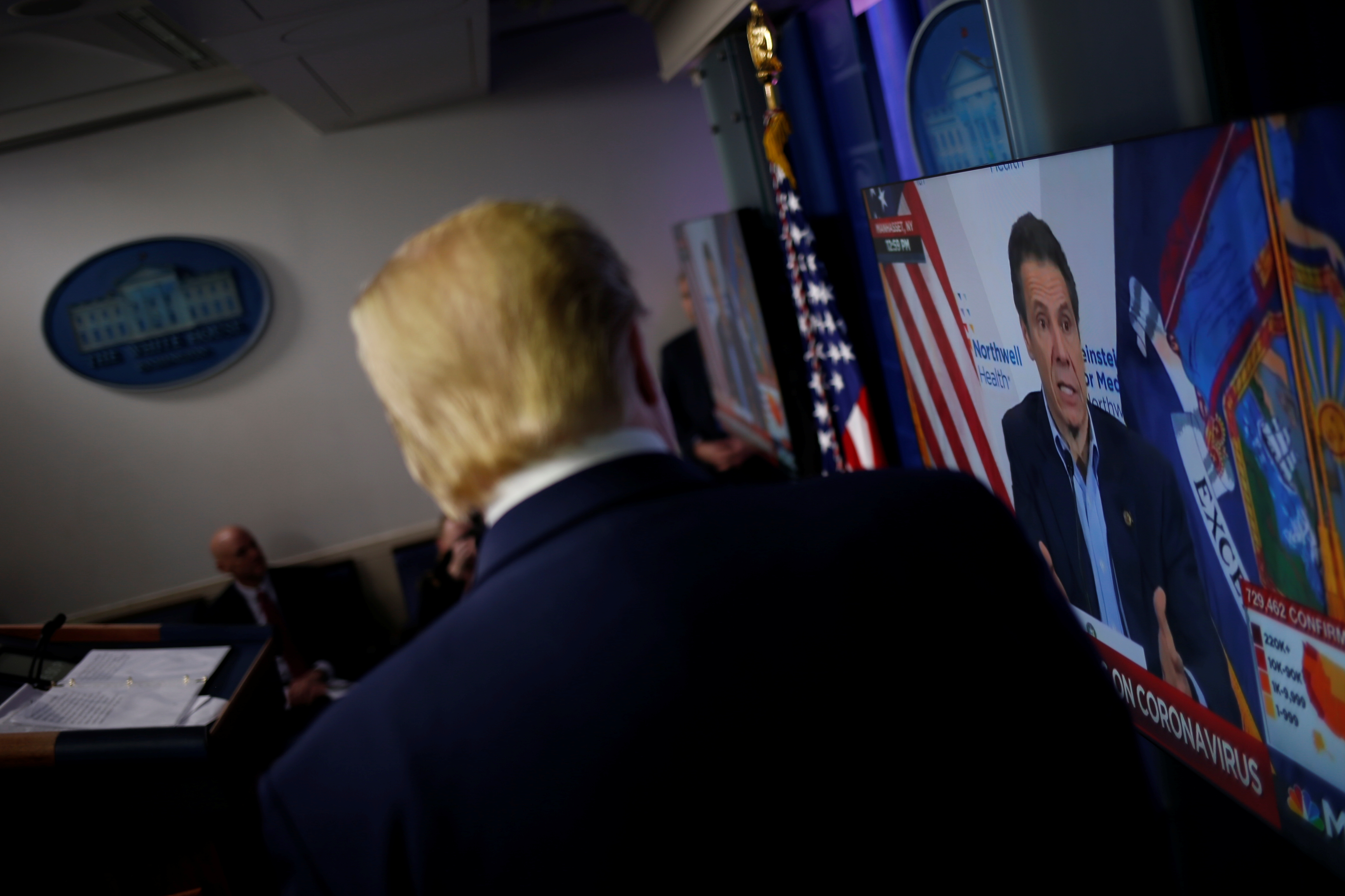 U.S. President Donald Trump watches a clip from MSNBC of New York governor Andrew Cuomo speaking at Cuomo's daily briefing, during the daily coronavirus disease (COVID-19) task force briefing at the White House in Washington, U.S., April 19, 2020