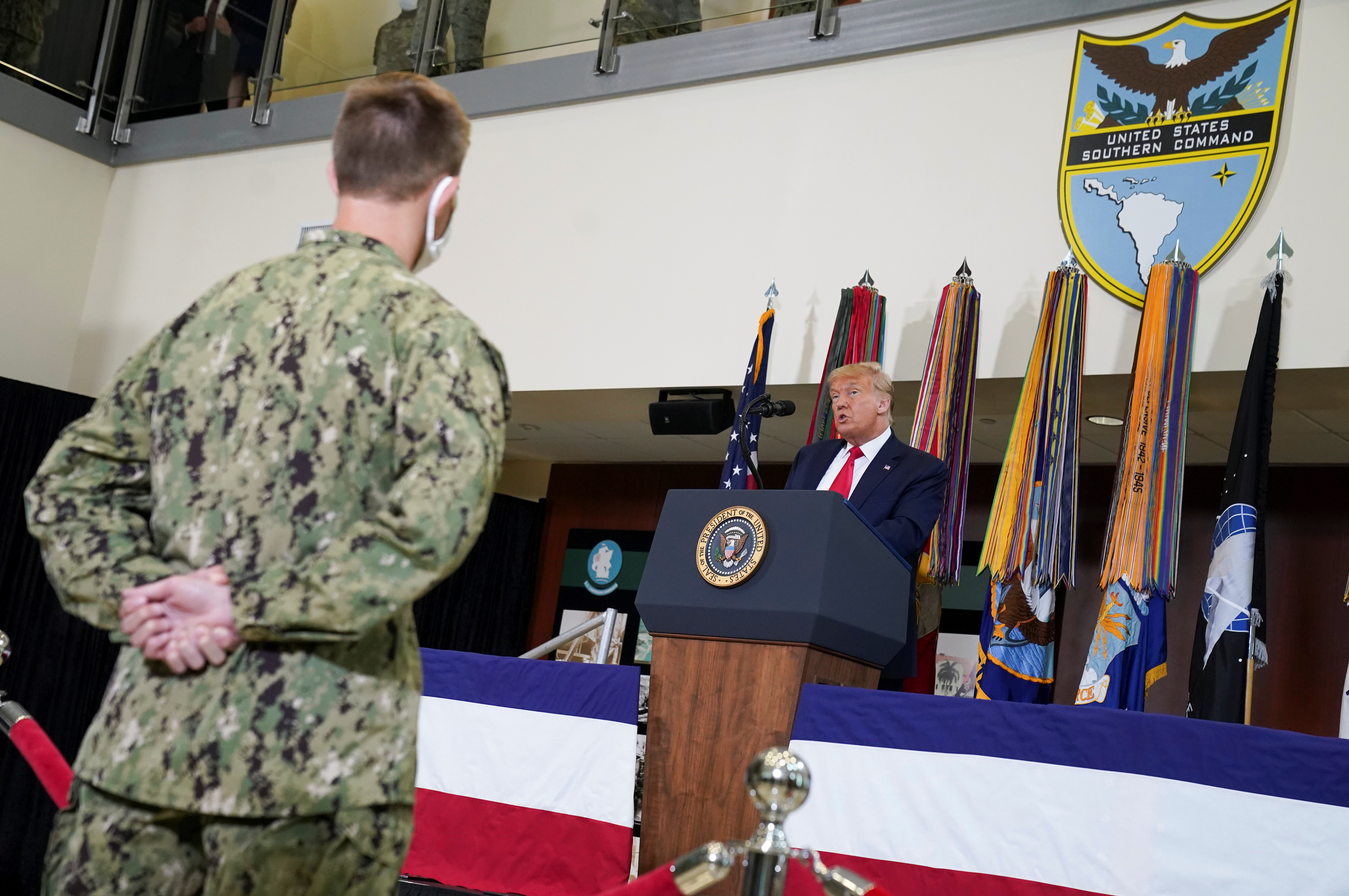 A member of the U.S. military listens as President Donald Trump speaks about SOUTHCOM Enhanced Counternarcotics Operations as he visits the U.S. Southern Command (SOUTHCOM) in Doral, Florida, U.S., July 10, 2020. REUTERS/Kevin Lamarque