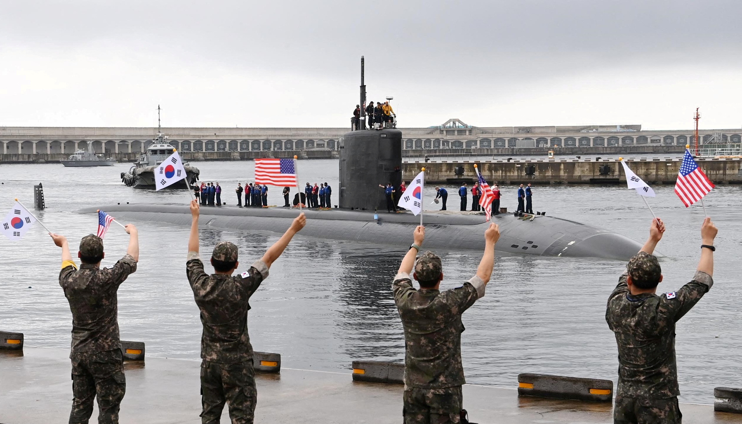 The U.S. nuclear-powered submarine USS Annapolis is greeted by South Korean Navy soldiers upon its arrival at a naval base on Jeju Island