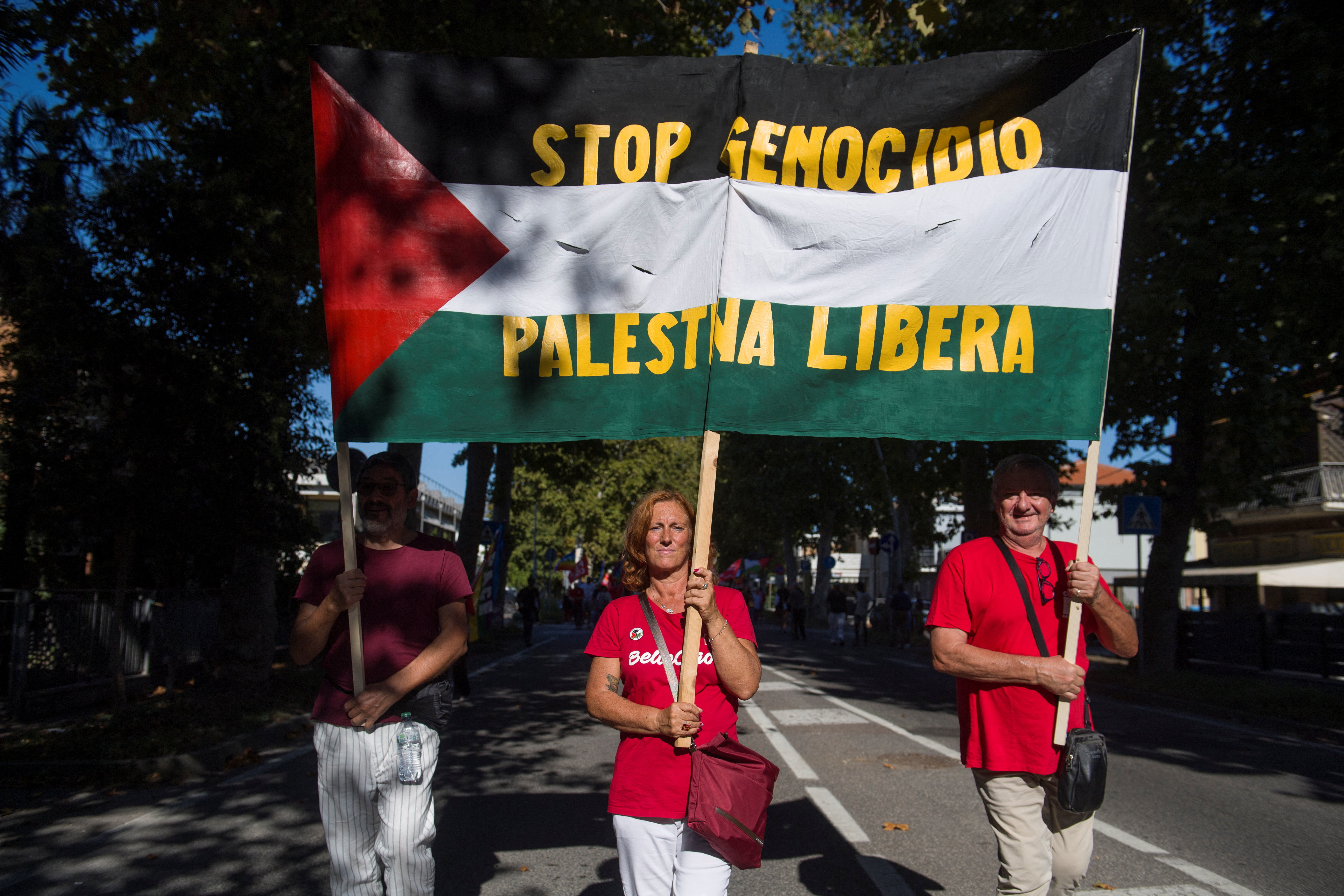 People march with a banner in reading "Stop genocide, free Palestine" in Italian, during a four-hour strike and rally called by the CGIL trade union as part of a nationwide day of mobilization across sectors, with demonstrations held throughout the country to protest against the war in Gaza, in Ravenna, Italy, September 19, 2025. REUTERS/Michele Lapini