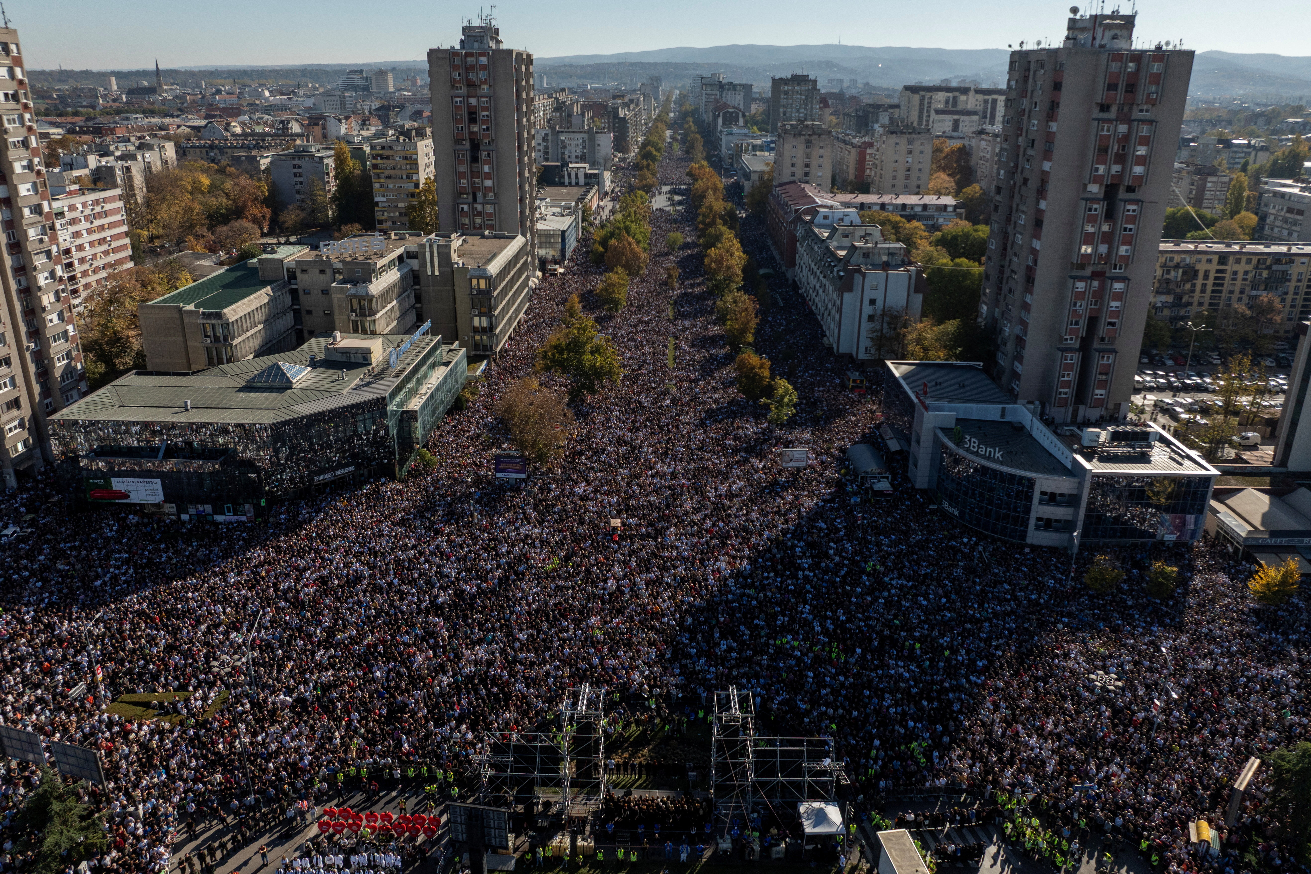 A drone view shows people keeping 16 minutes of silence outside Novi Sad railway station during a commemorative service [Marko Djurica/Reuters]