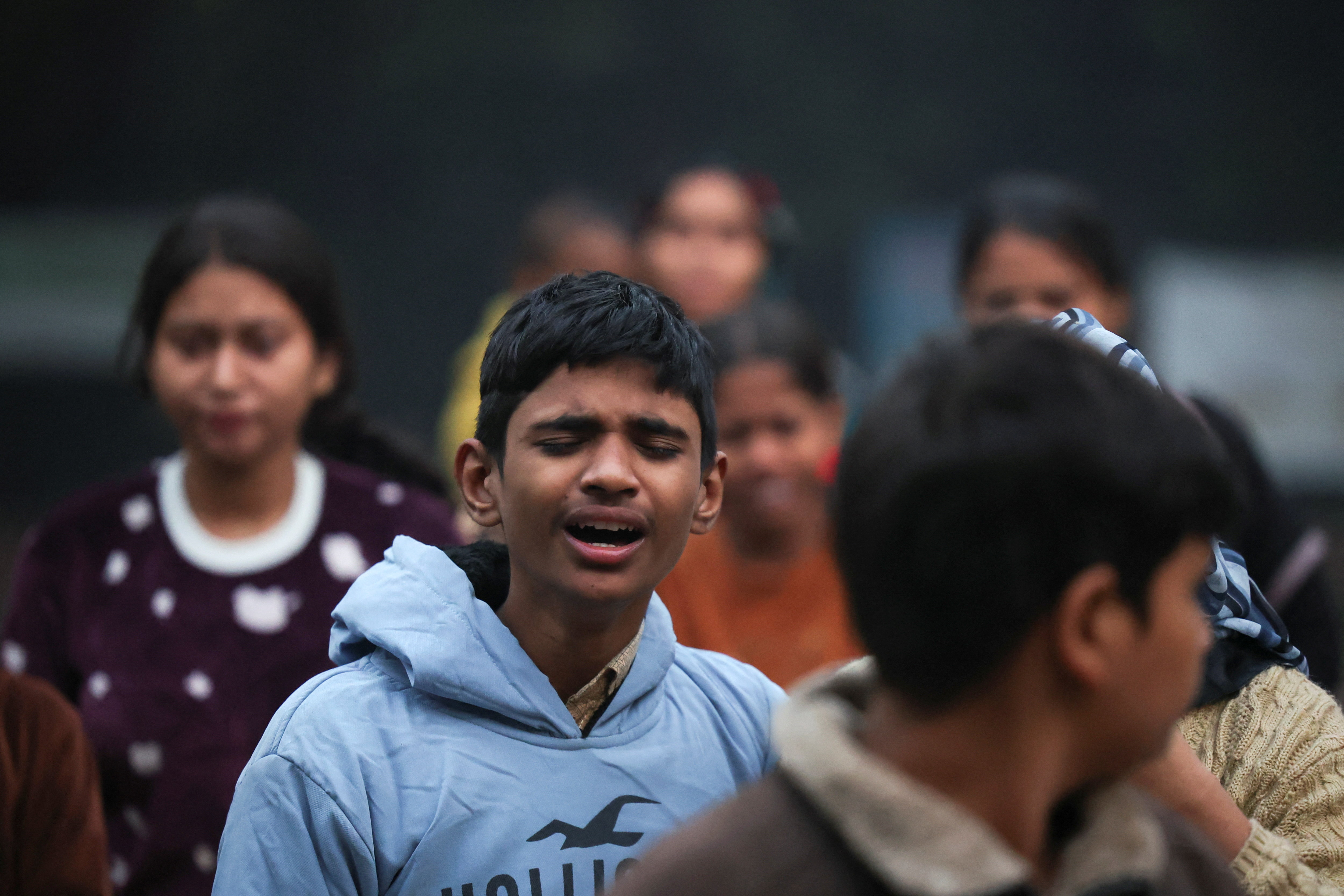 The son of a victim of an explosion near the Red Fort in the old quarters of Delhi mourns outside a mortuary