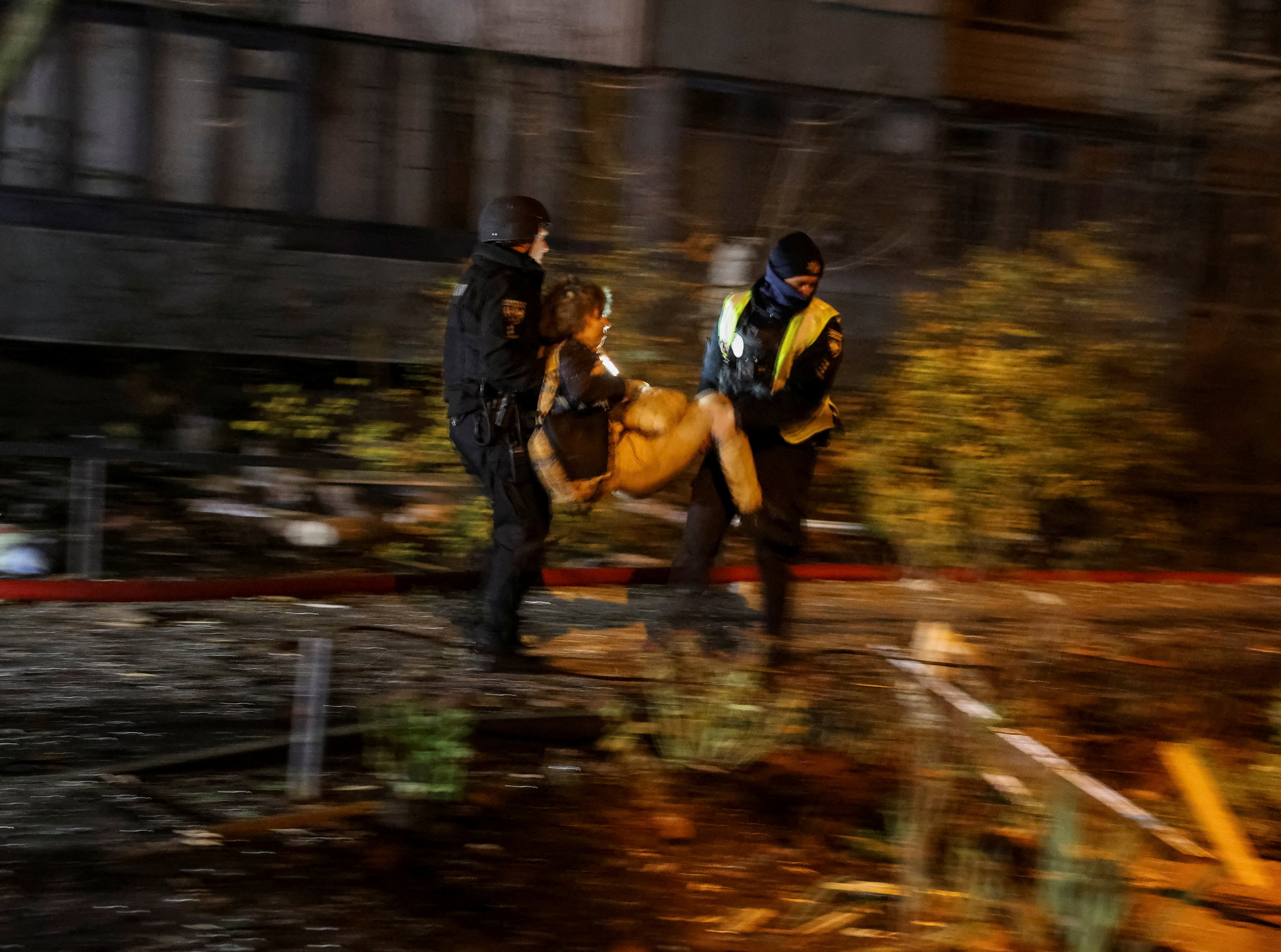 Police officers evacuate a resident from an apartment building hit during an overnight Russian drone and missile strike, amid Russia's attack on Ukraine, in Kyiv, Ukraine November 14, 2025. Radio Free Europe/Radio Liberty/Serhii Nuzhnenko via REUTERS TPX IMAGES OF THE DAY