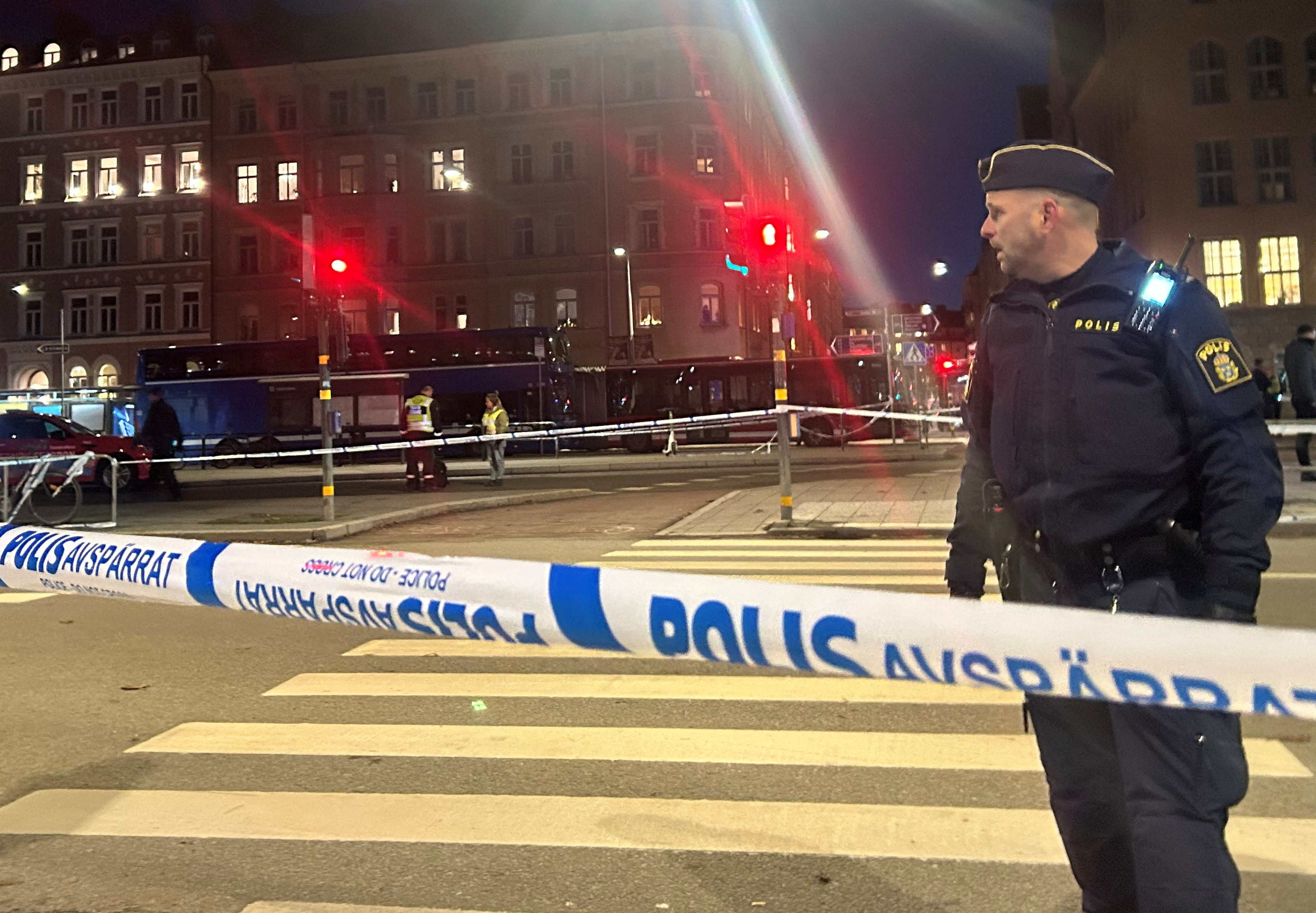 A Swedish officer stands near the site where a bus hit a bus stop in central Stockholm, Sweden, November 14, 2025.