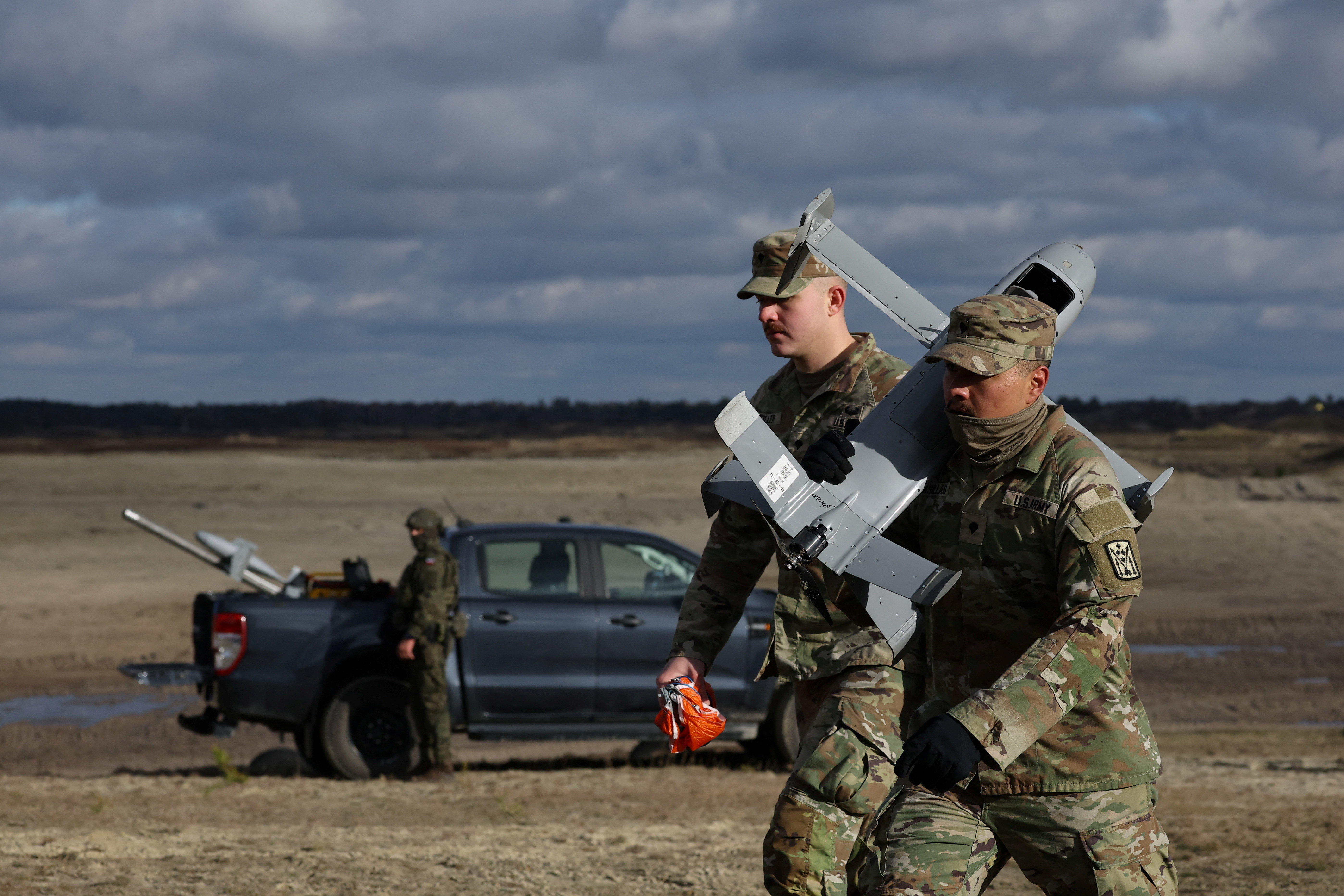 U.S. soldier carries an AS3 interceptor, part of a modular American-made AI-powered counter-drone system MEROPS, during a presentation at a polygon in Nowa Deba, Poland, November 18, 2025. REUTERS/Kacper Pempel