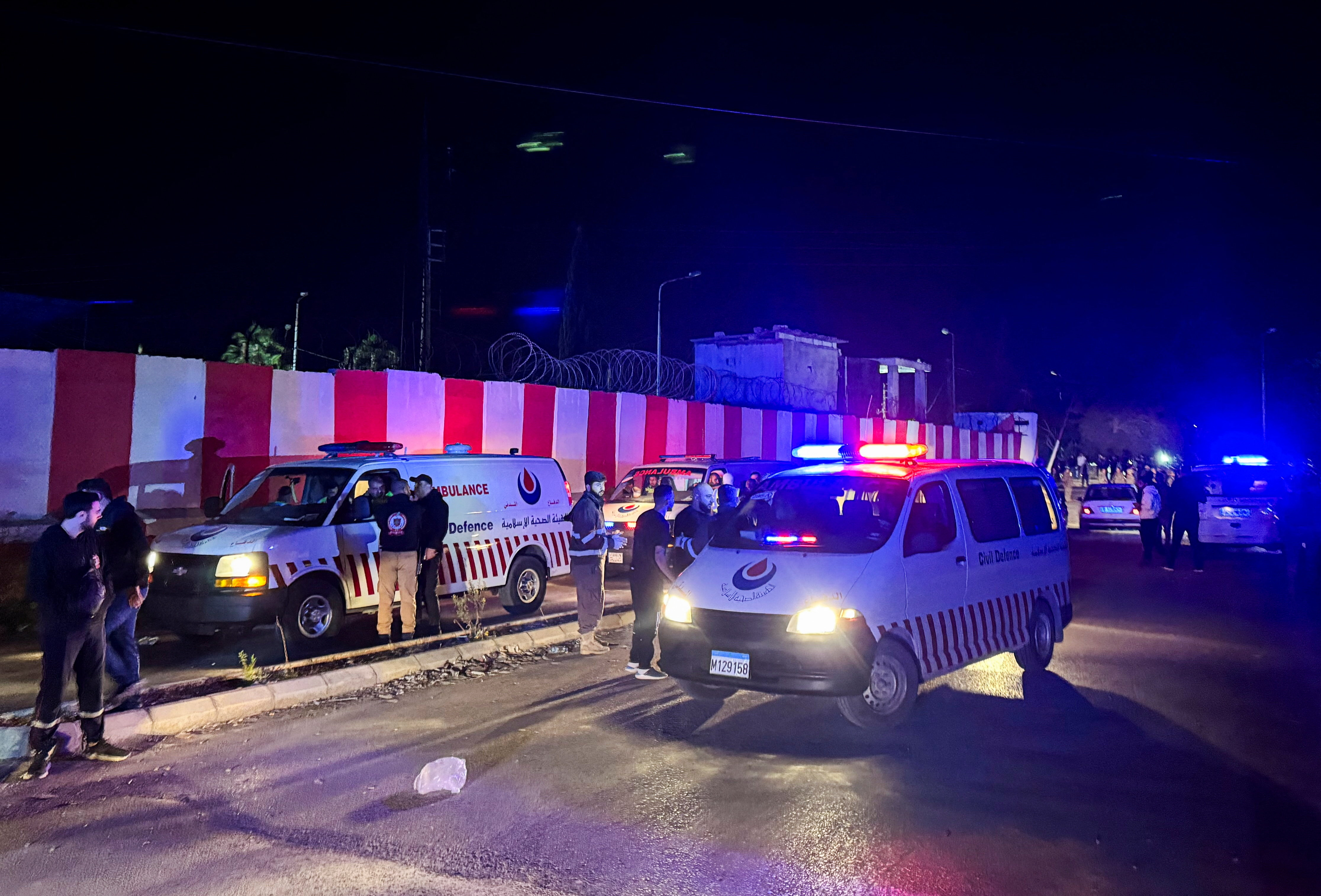 Civil defence vehicles park at the entrance of Ain al-Hilweh Palestinian refugee camp, following an Israeli attack [Ali Hankir/Reuters]