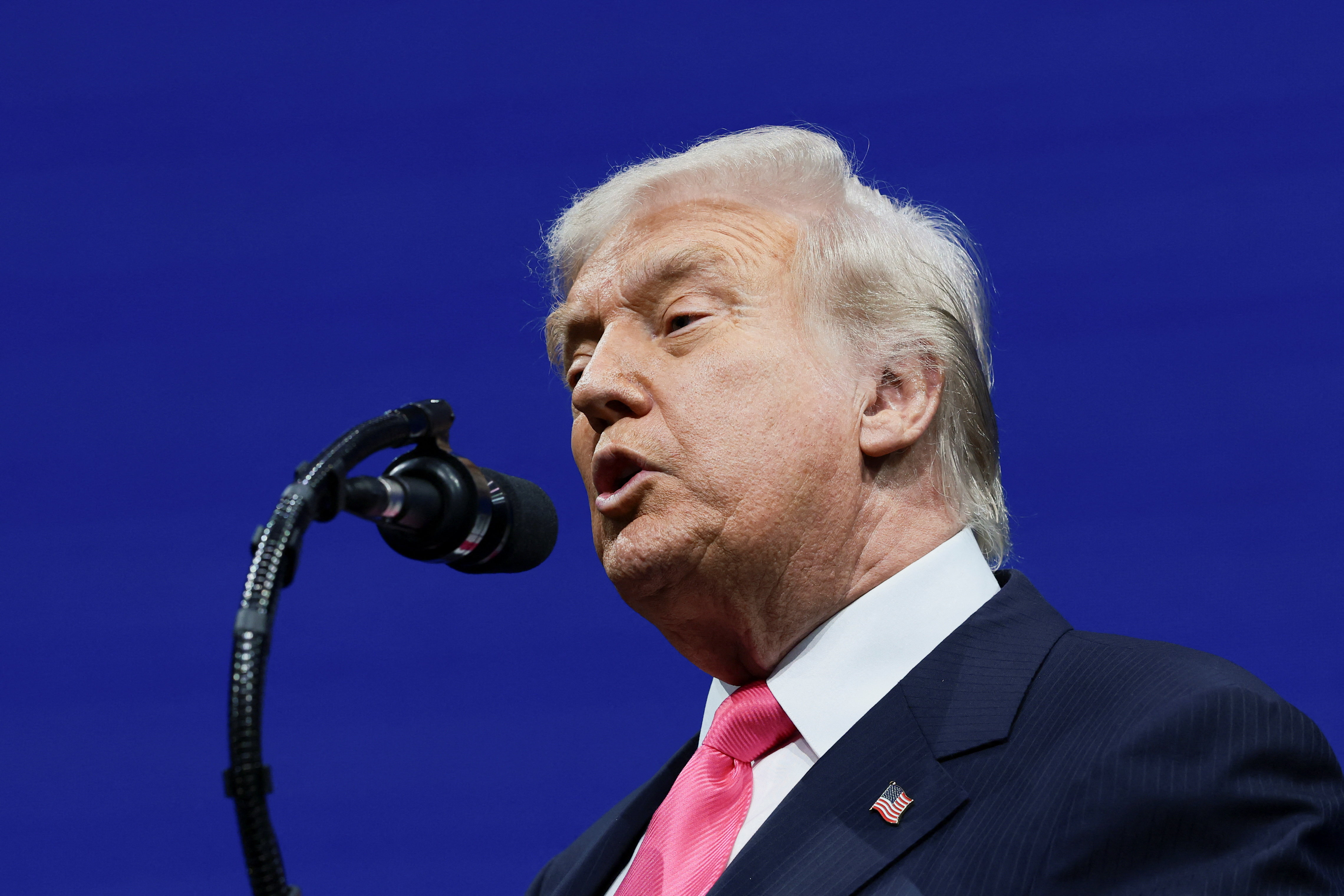 Donald Trump speaks into a microphone