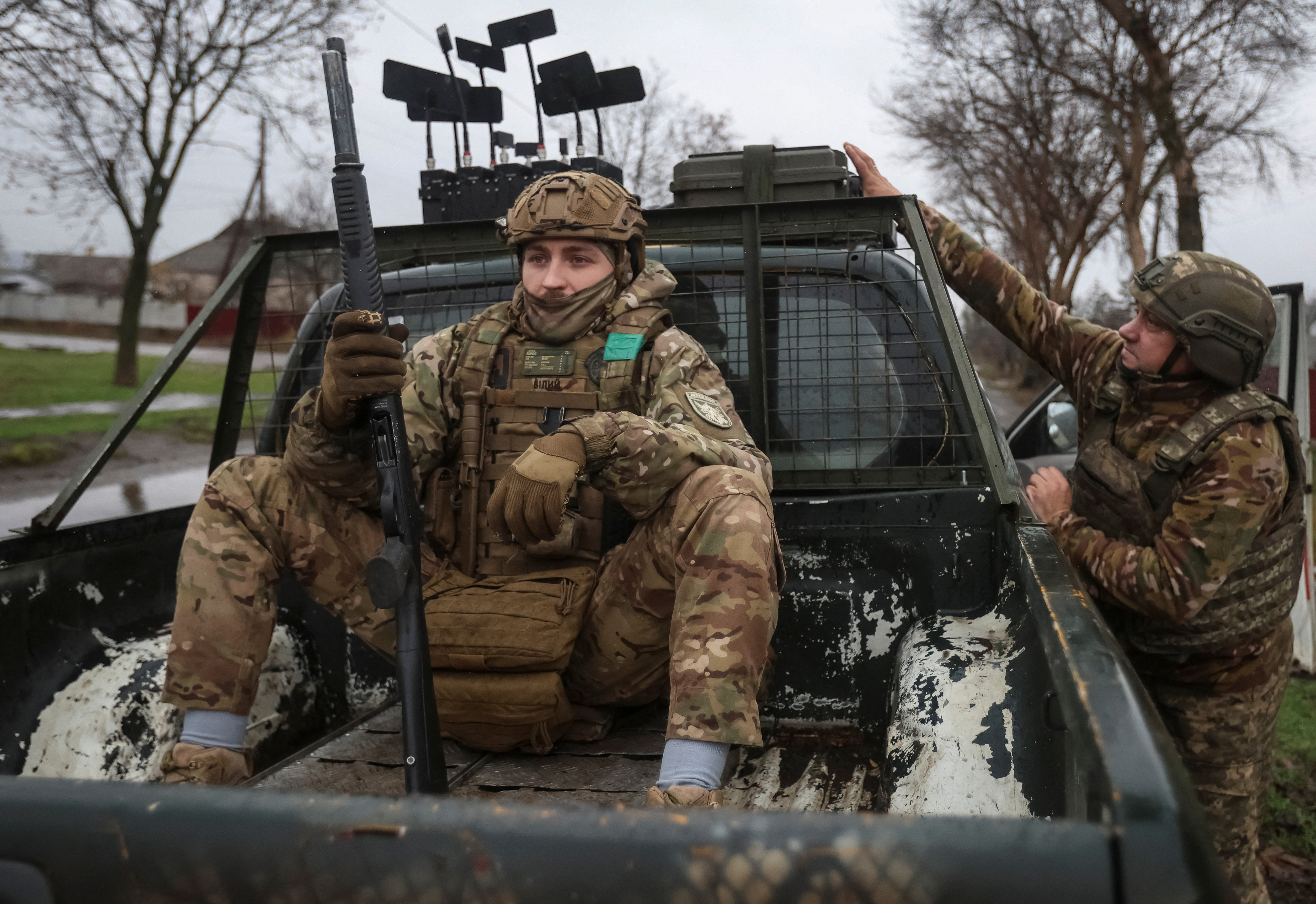 A serviceman of the 93rd Kholodnyi Yar Separate Mechanised Brigade of the Ukrainian Armed Forces sits in a pickup truck as his counterpart prepares electronic warfare systems, before a combat mission, amid Russia's attack on Ukraine, near the frontline town of Kostiantynivka in Donetsk region, Ukraine, November 20, 2025. REUTERS/Anatolii Stepanov