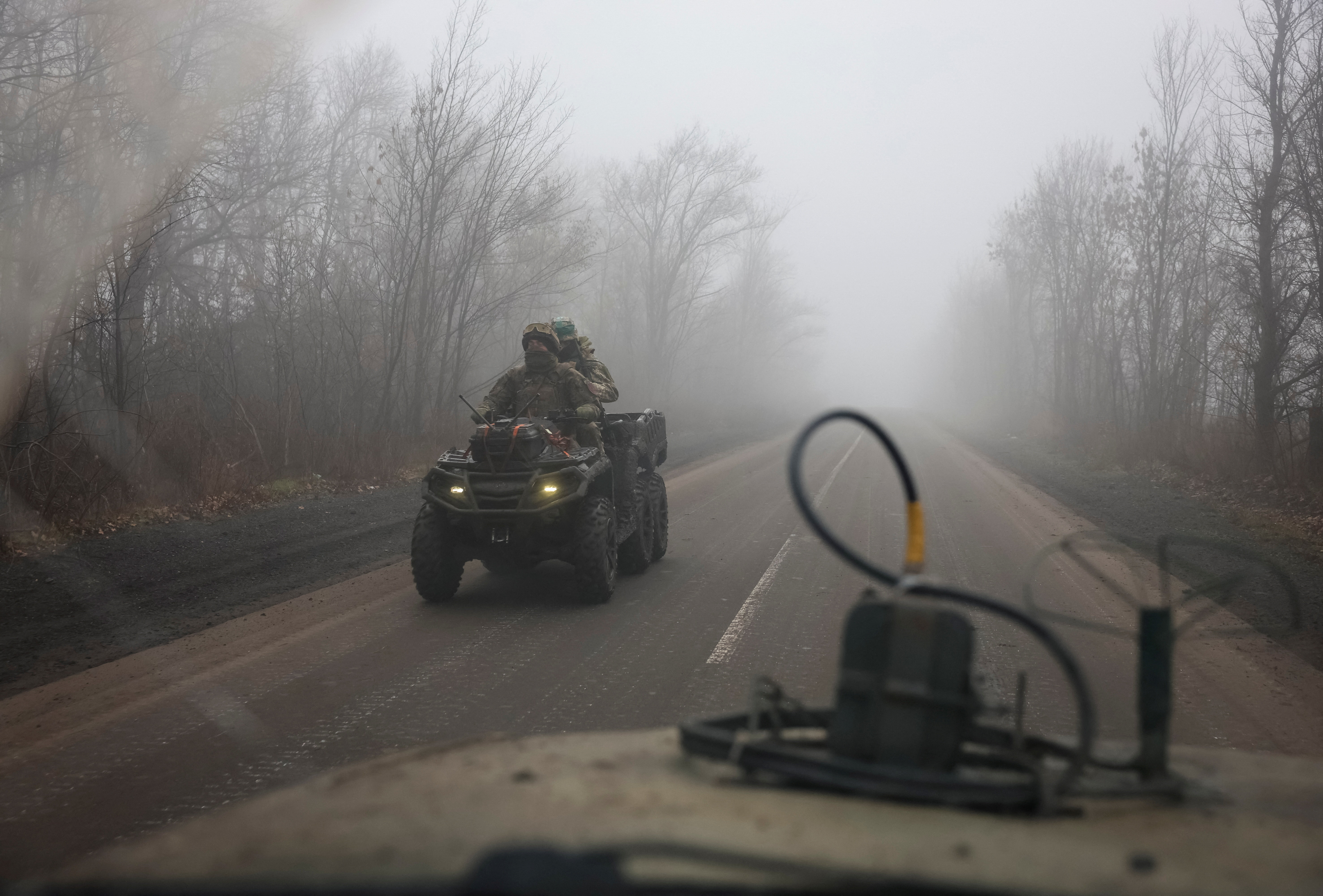 Ukrainian servicemen ride a military buggy along a road near a front line, amid Russia's attack on Ukraine, near the frontline town of Pokrovsk in Donetsk region, Ukraine November 23, 2025. REUTERS/Anatolii Stepanov