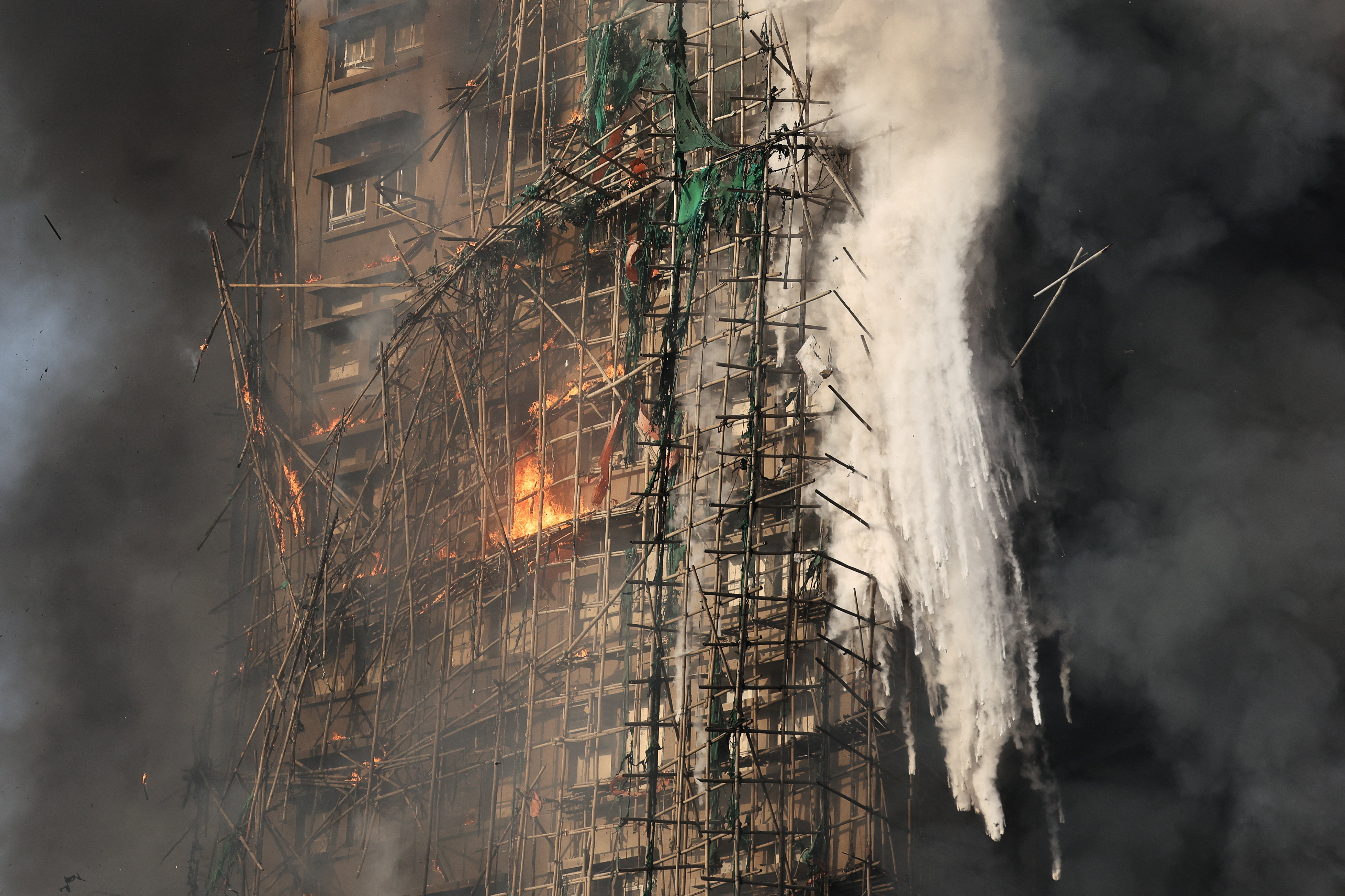 bamboo scaffolding and green netting catches fire