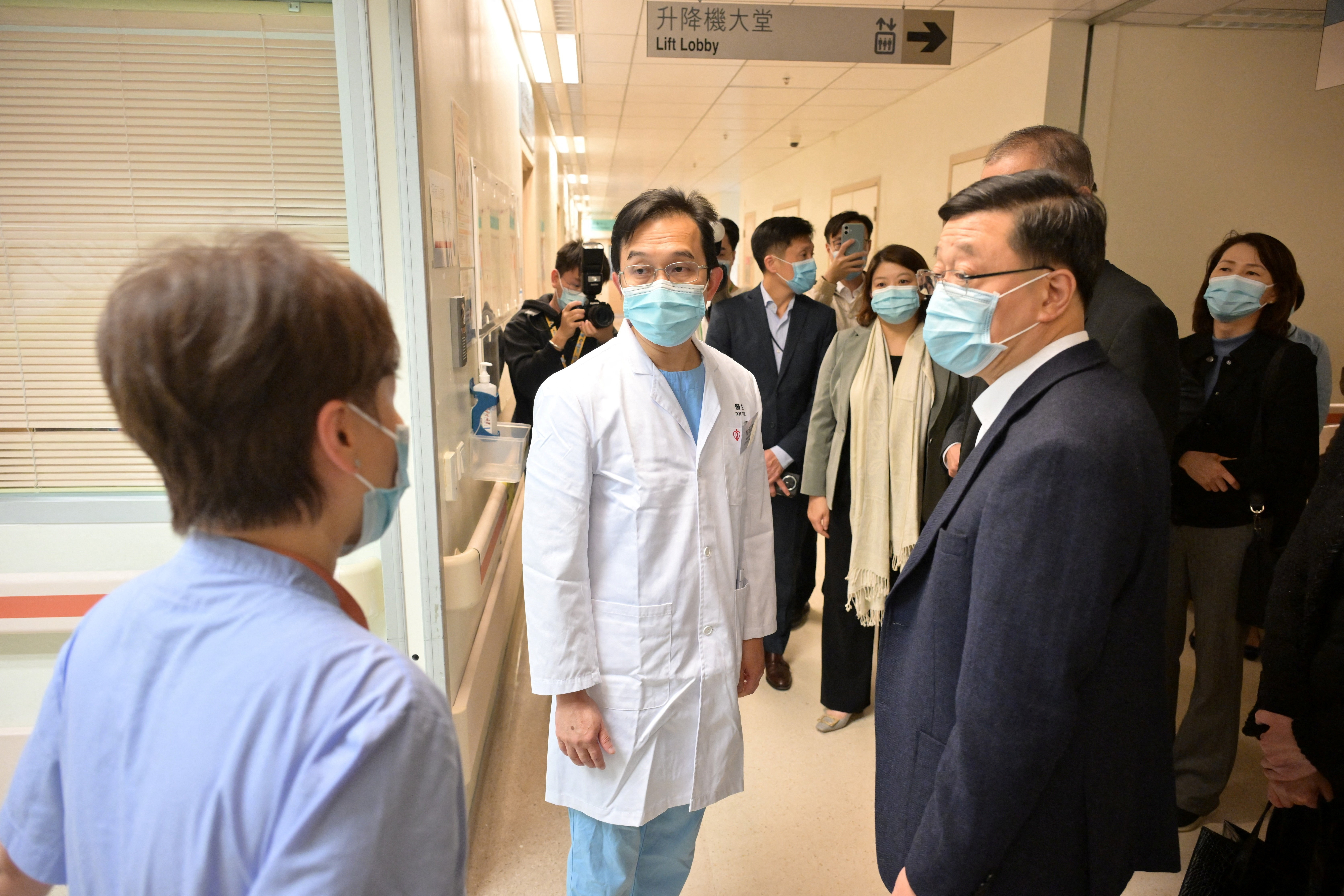 Hong Kong Chief Executive John Lee visits injured persons at the Prince of Wales Hospital after the deadly fire at Wang Fuk Court housing complex in Tai Po, in Hong Kong, China in this handout image released November 27, 2025. Hong Kong Information Services Department/Handout via REUTERS ATTENTION EDITORS - THIS IMAGE WAS PROVIDED BY A THIRD PARTY. NO RESALES. NO ARCHIVES.