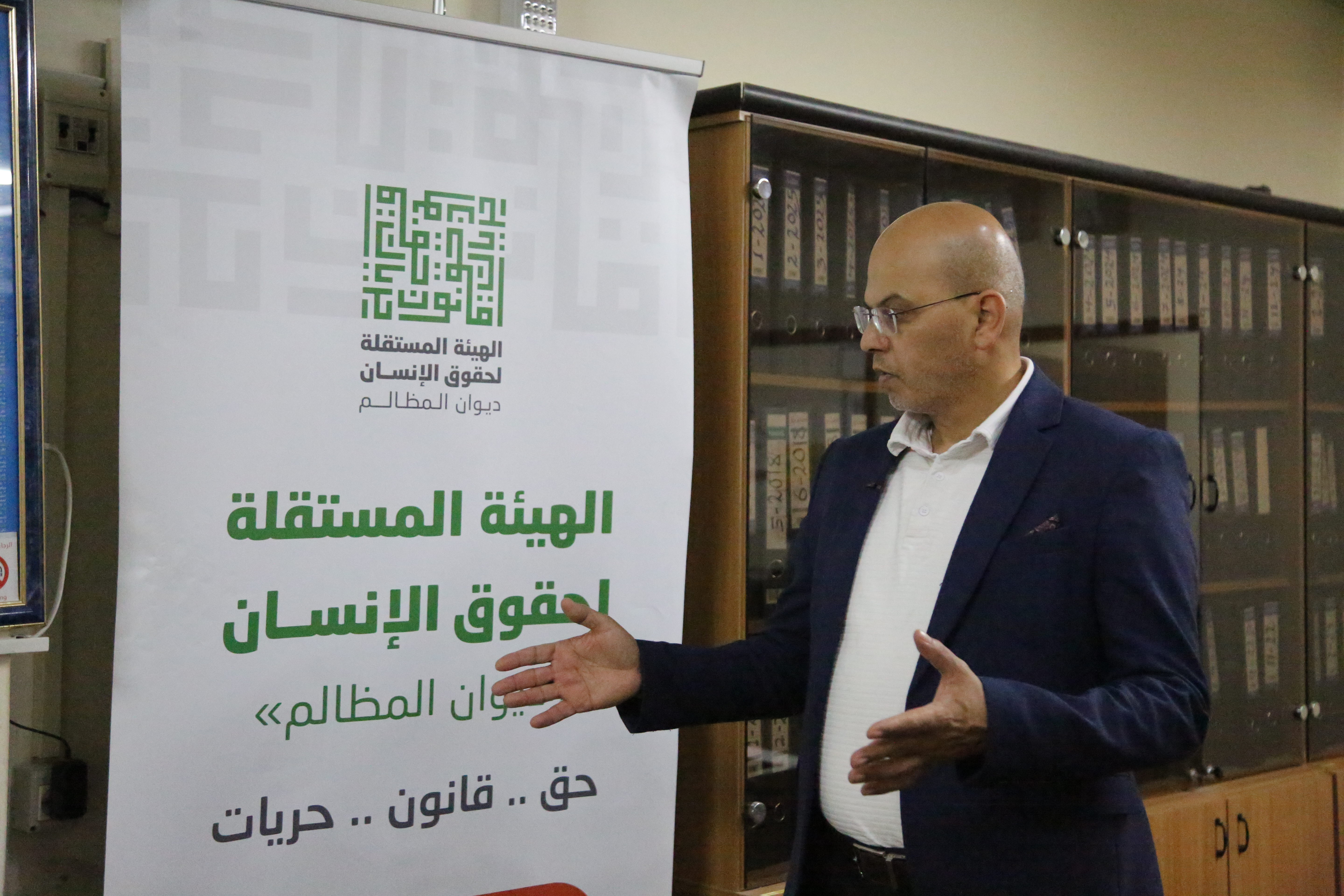 Farid al-Atrash stands in front of a banner