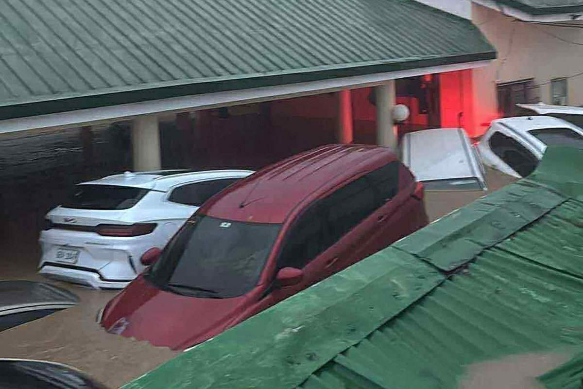 This screengrab shows cars submerged in floodwaters brought by Typhoon Kalmaegi in a village in Cebu province