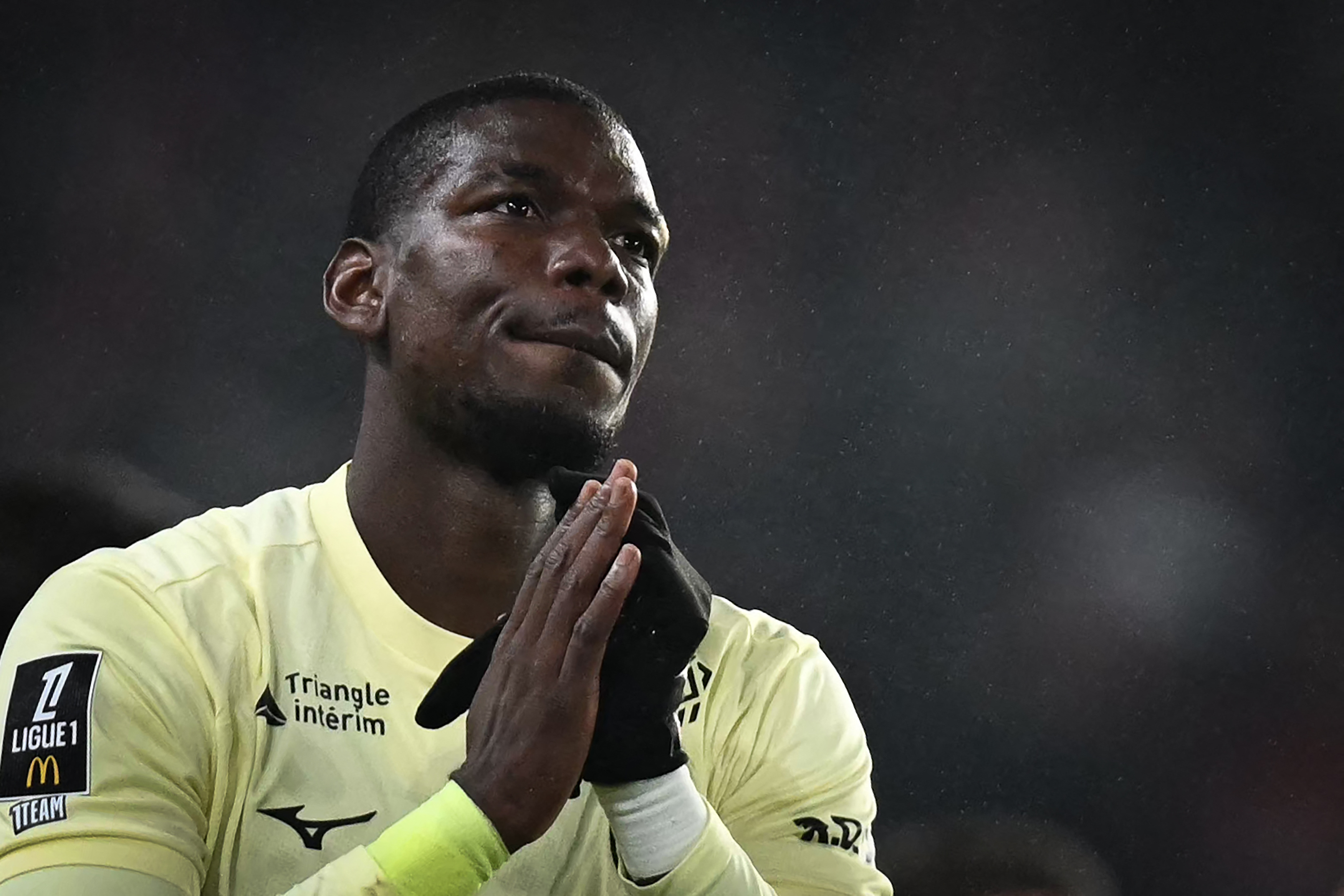 Paul Pogba gestures to the crowd at a match.