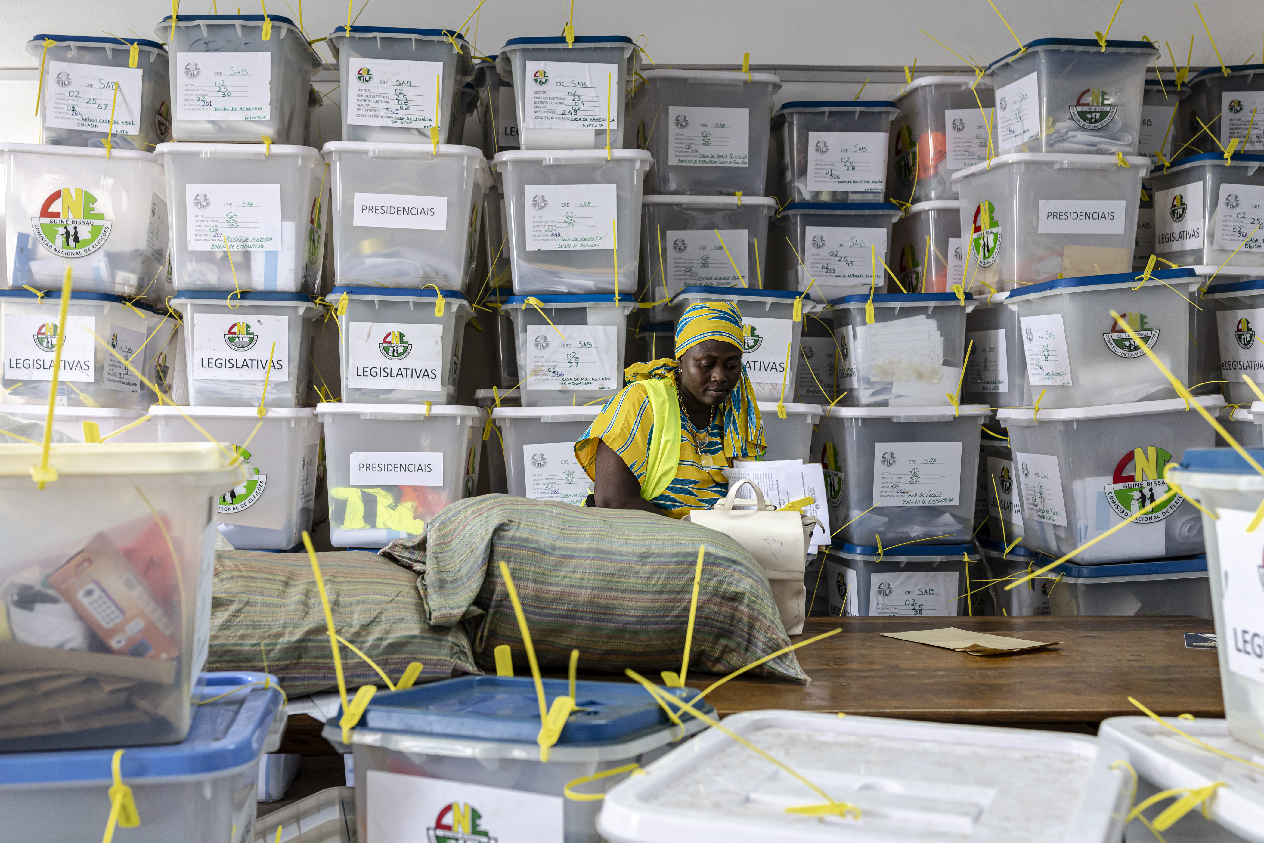 An official from the National Electoral Commission walks past ballot boxes full of electoral materials at their headquarters
