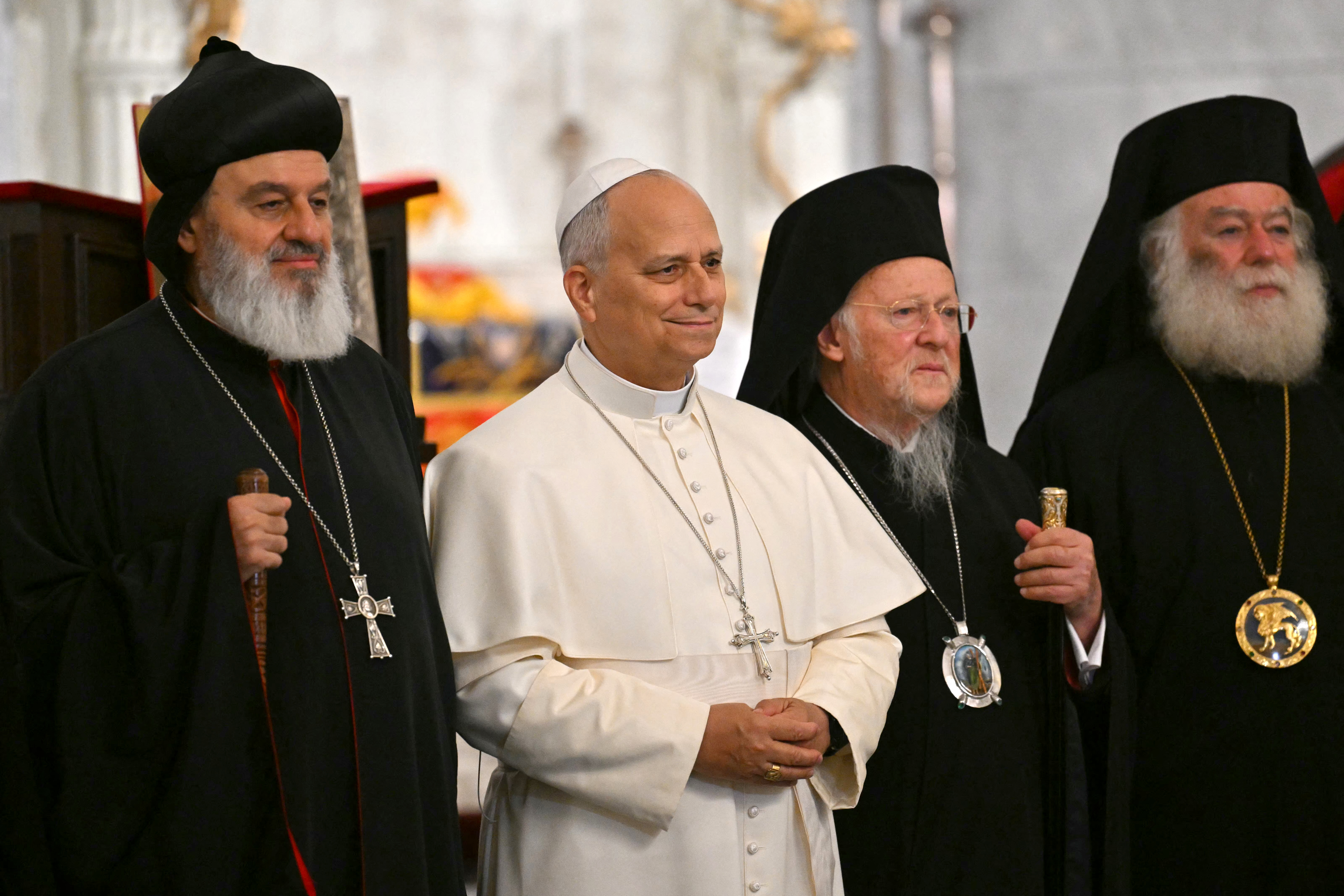 Pope Leo XIV stands with patriarch Mor Ignatius Aphrem II (L) and patriarch Bortholomew I as he arrives for a private meeting with religious leaders at the Mor Ephrem Syriac Orthodox Church, in Istanbul on November 29, 2025