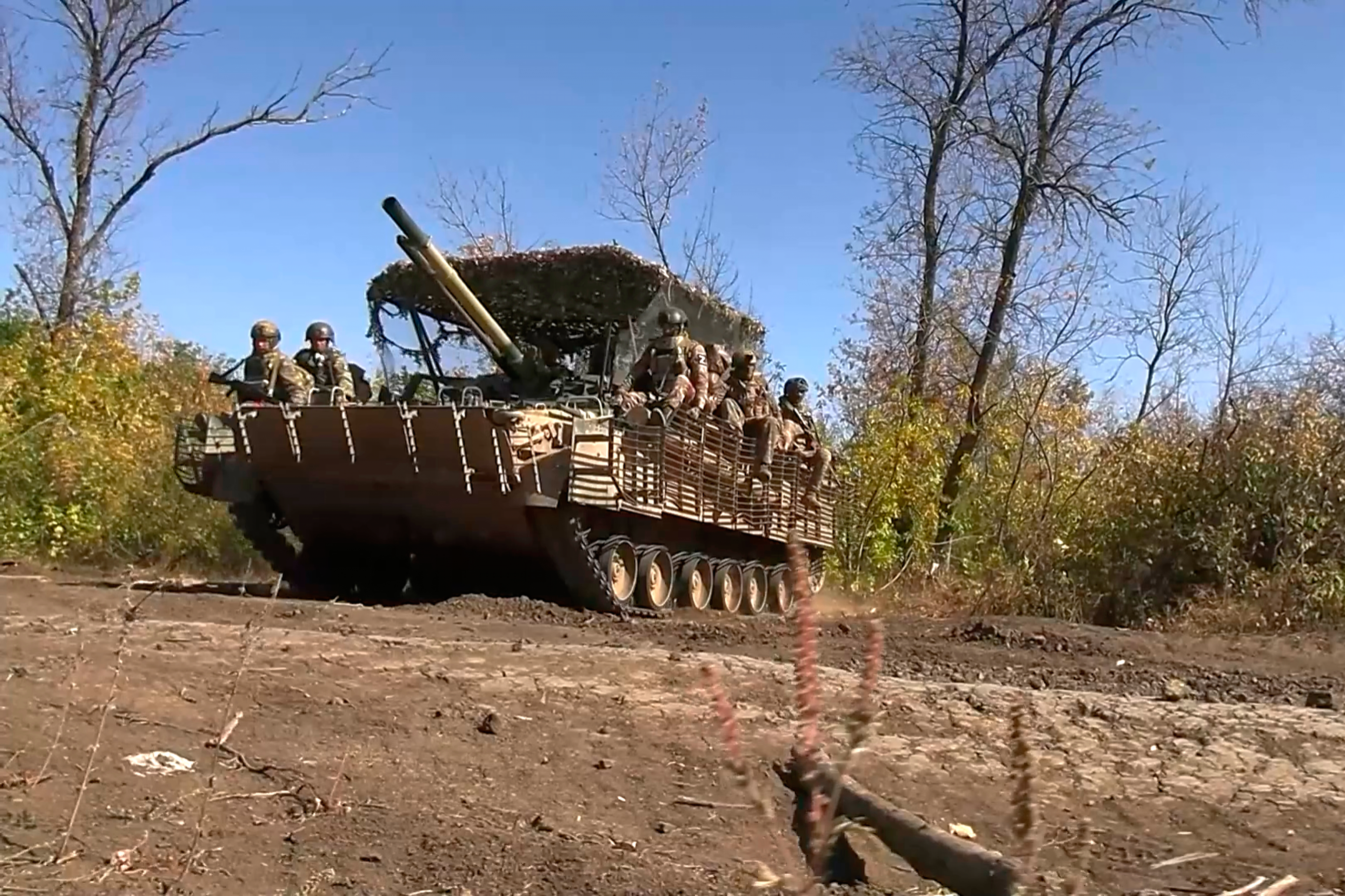 Russian servicemen ride an APC.