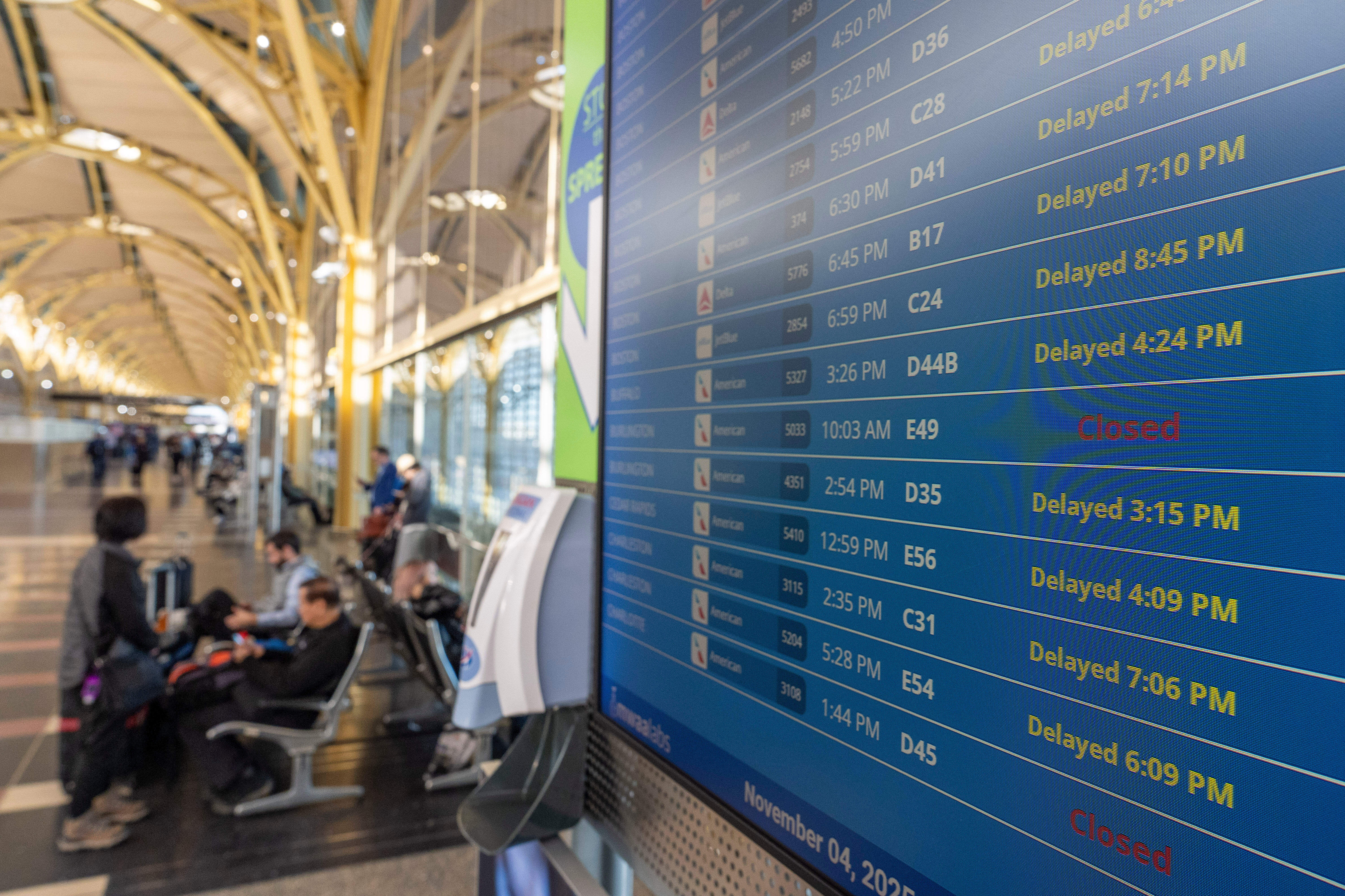 The departures display board shows multiple flights delayed at Ronald Reagan Washington National Airport, in Arlington, Virginia, USA