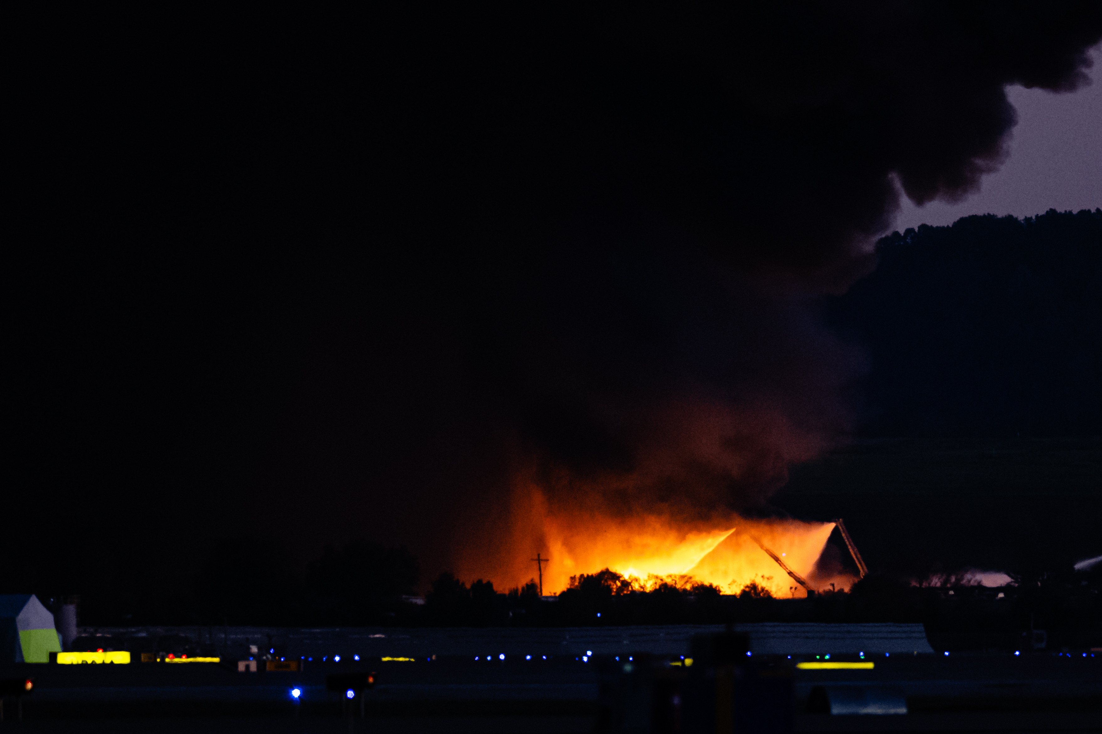 A plume of smoke rises from the site of a UPS cargo plane crash.