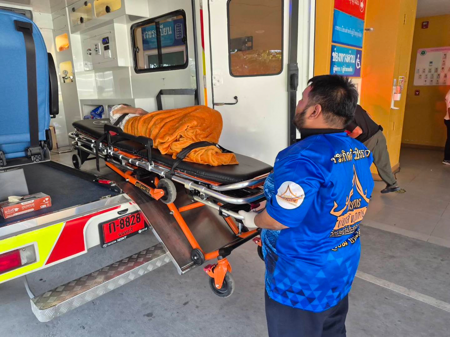 an emergency rescue team transports an elderly woman discovered to still be alive after being considered deceased to a local hospital before her scheduled cremation at Wat Rat Prakhong Tham temple, Nonthaburi province, Thailand. (Wat Rat Prakhong Tham via AP)