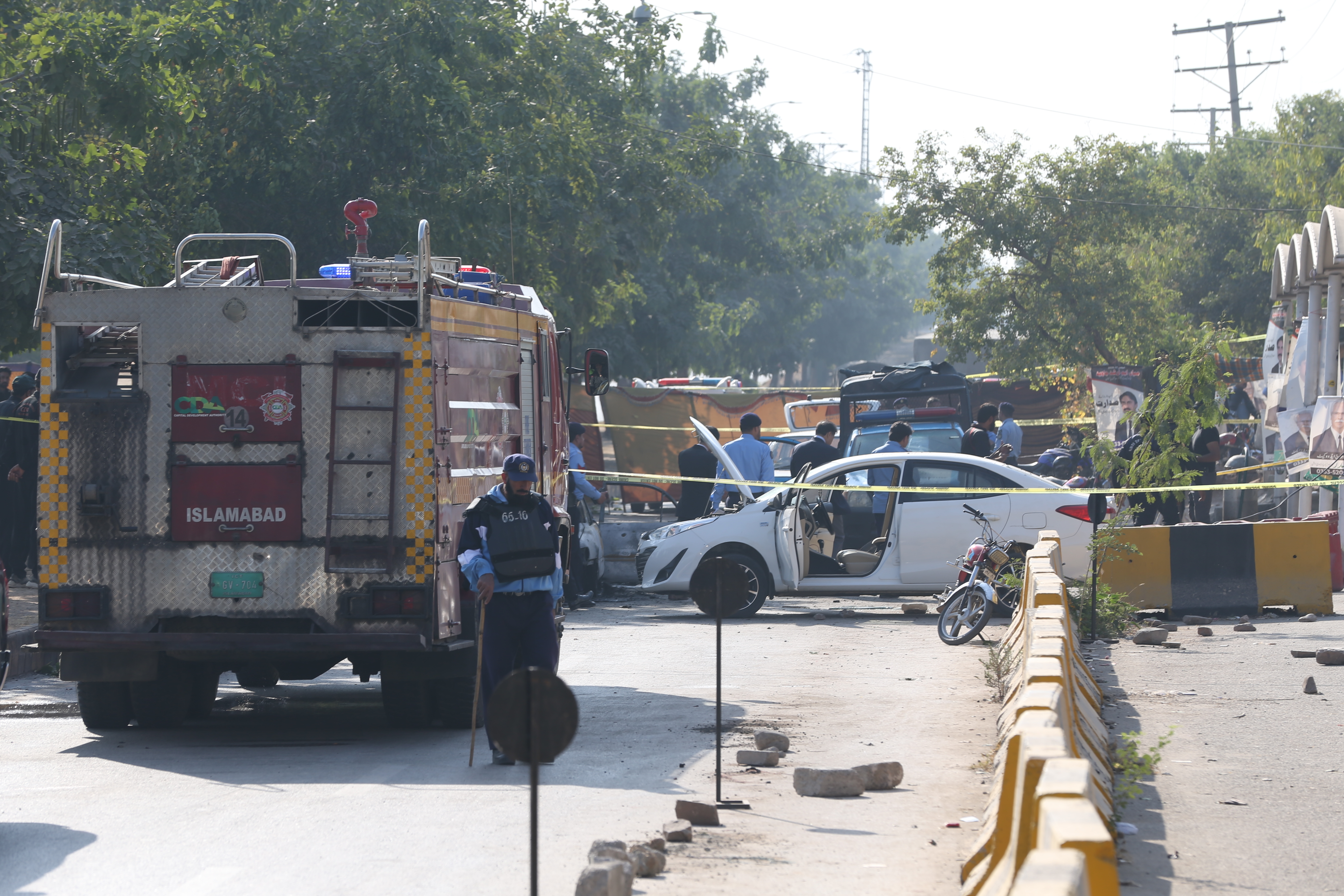 Security forces at the scene where at least 12 people were killed in an explosion outside a court complex in Islamabad