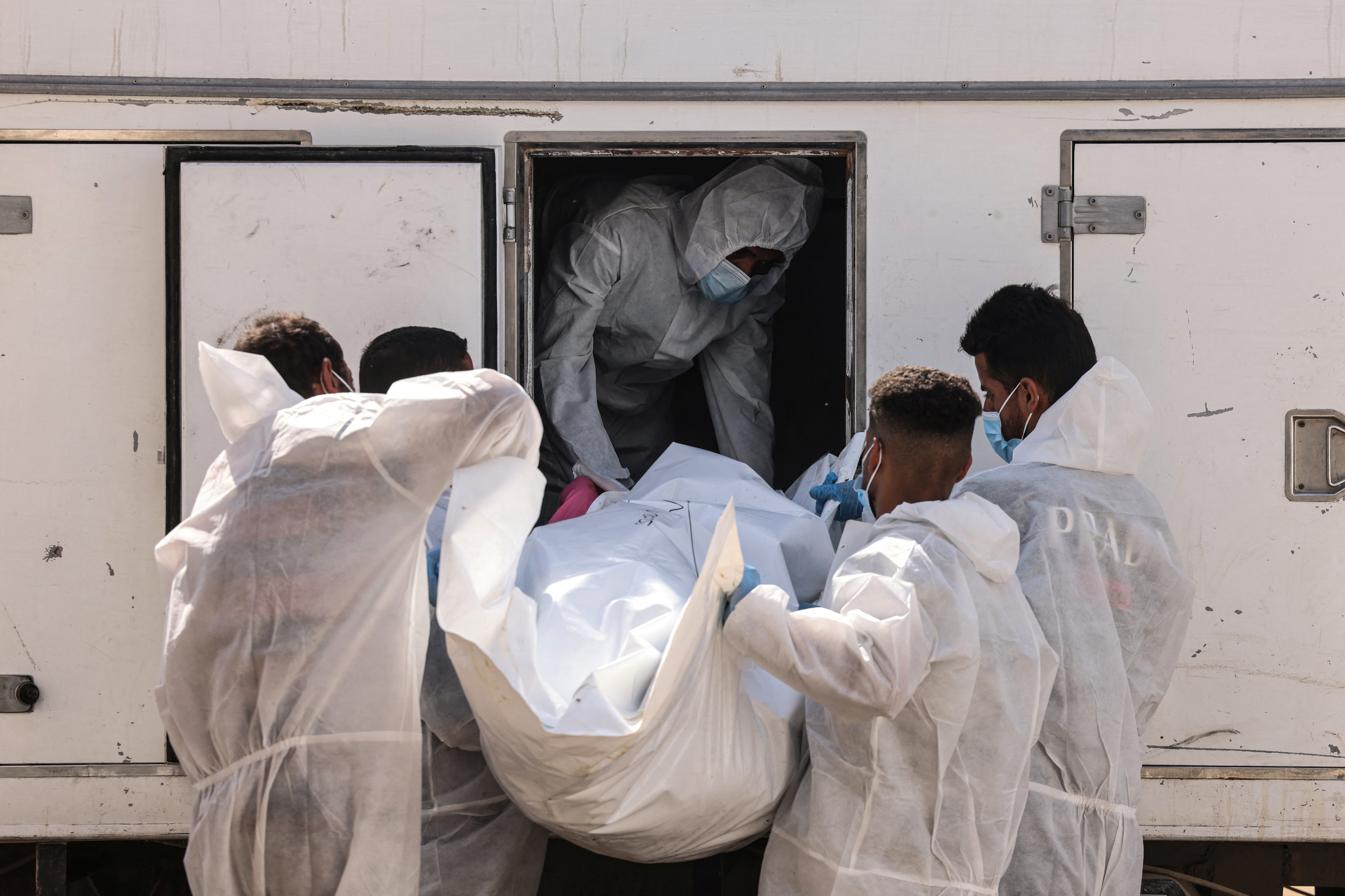 Medical workers unload a body of a Palestinian prisoner.