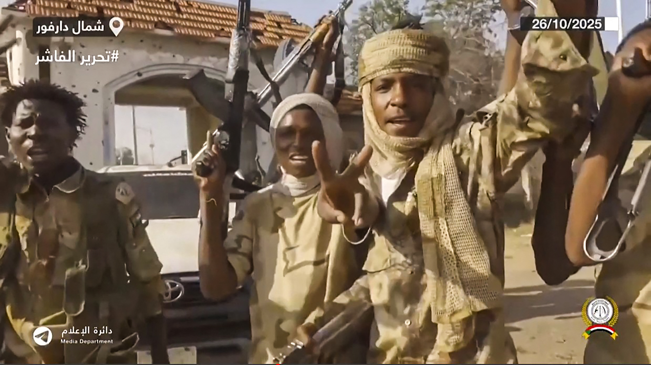 This image grab taken from handout video footage released on Sudan's paramilitary Rapid Support Forces (RSF) Telegram account on October 26, 2025, shows RSF fighters holding weapons and celebrating in the streets of El-Fasher in Sudan's Darfur.