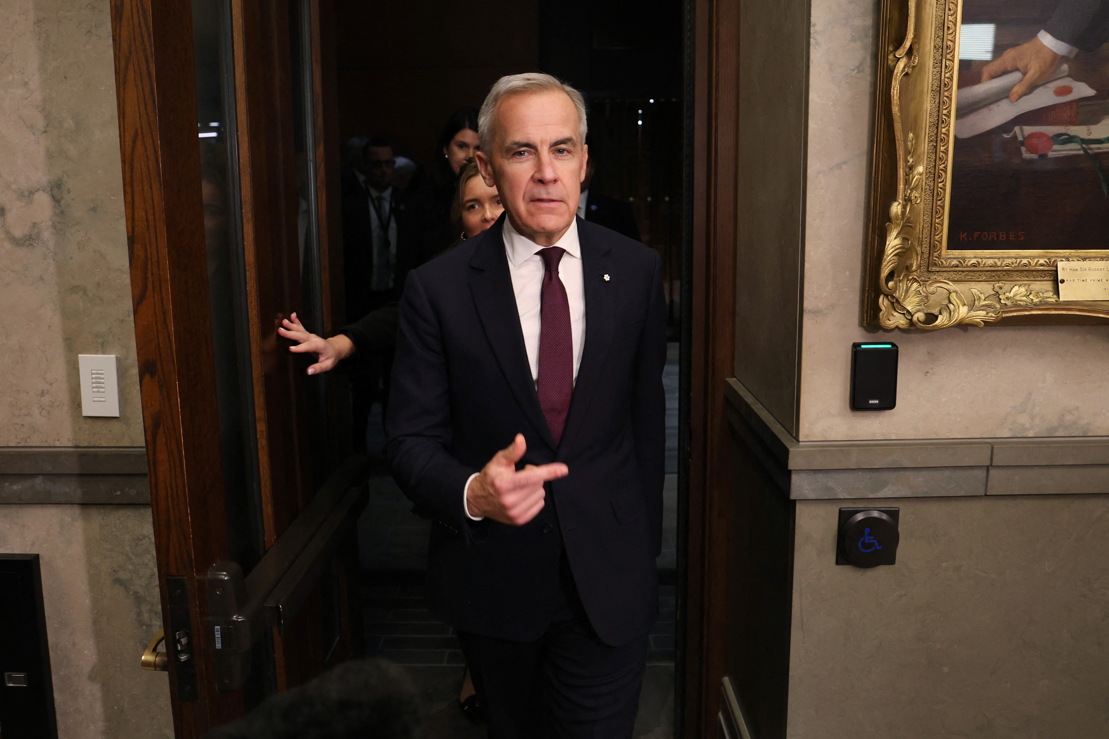Canada's Prime Minister Mark Carney exits the House of Commons after attending Question Period on Parliament Hill on November 17, 2025 in Ottawa, Canada.