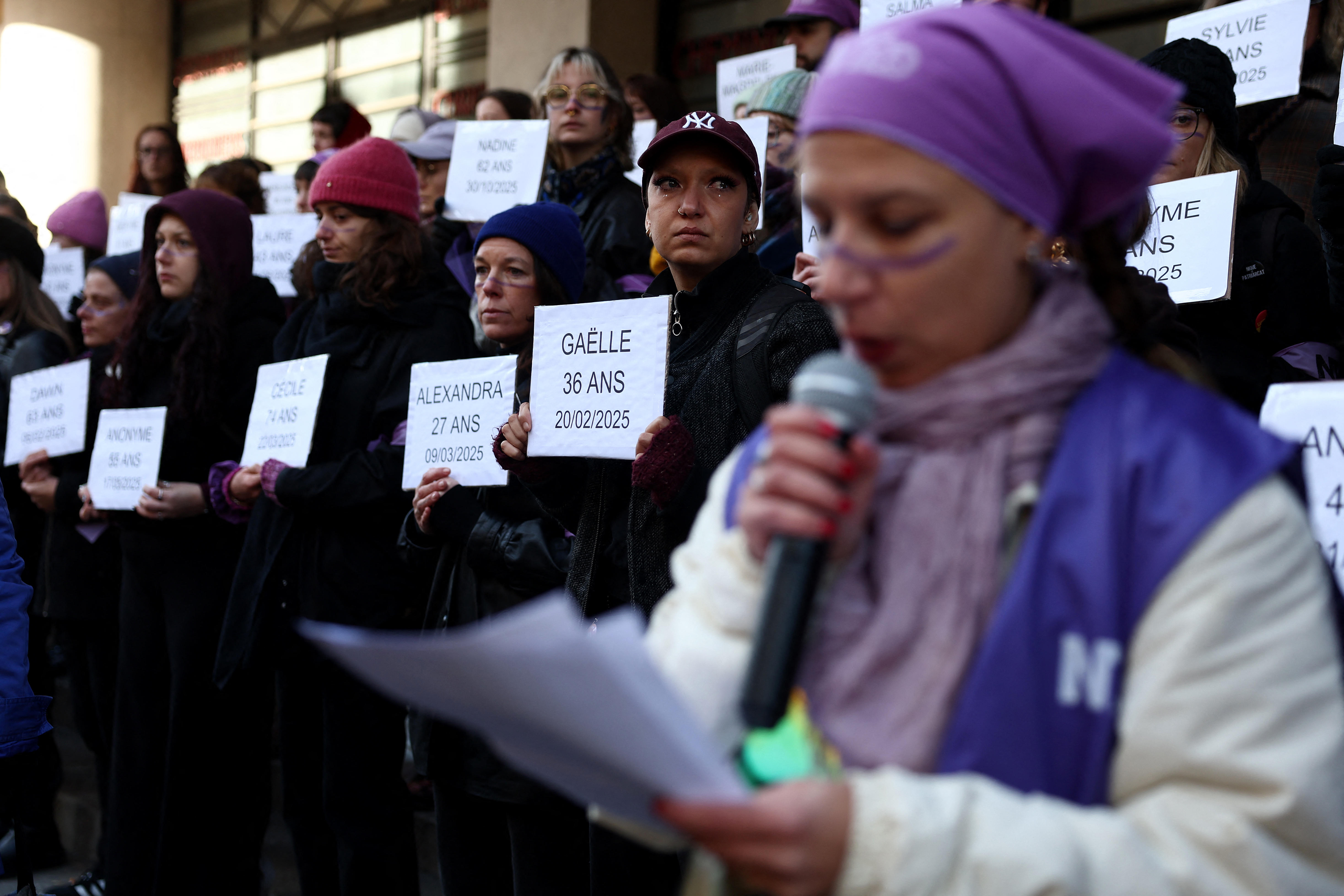 Protesters display the names of victims of femicide during a rally in southwestern France