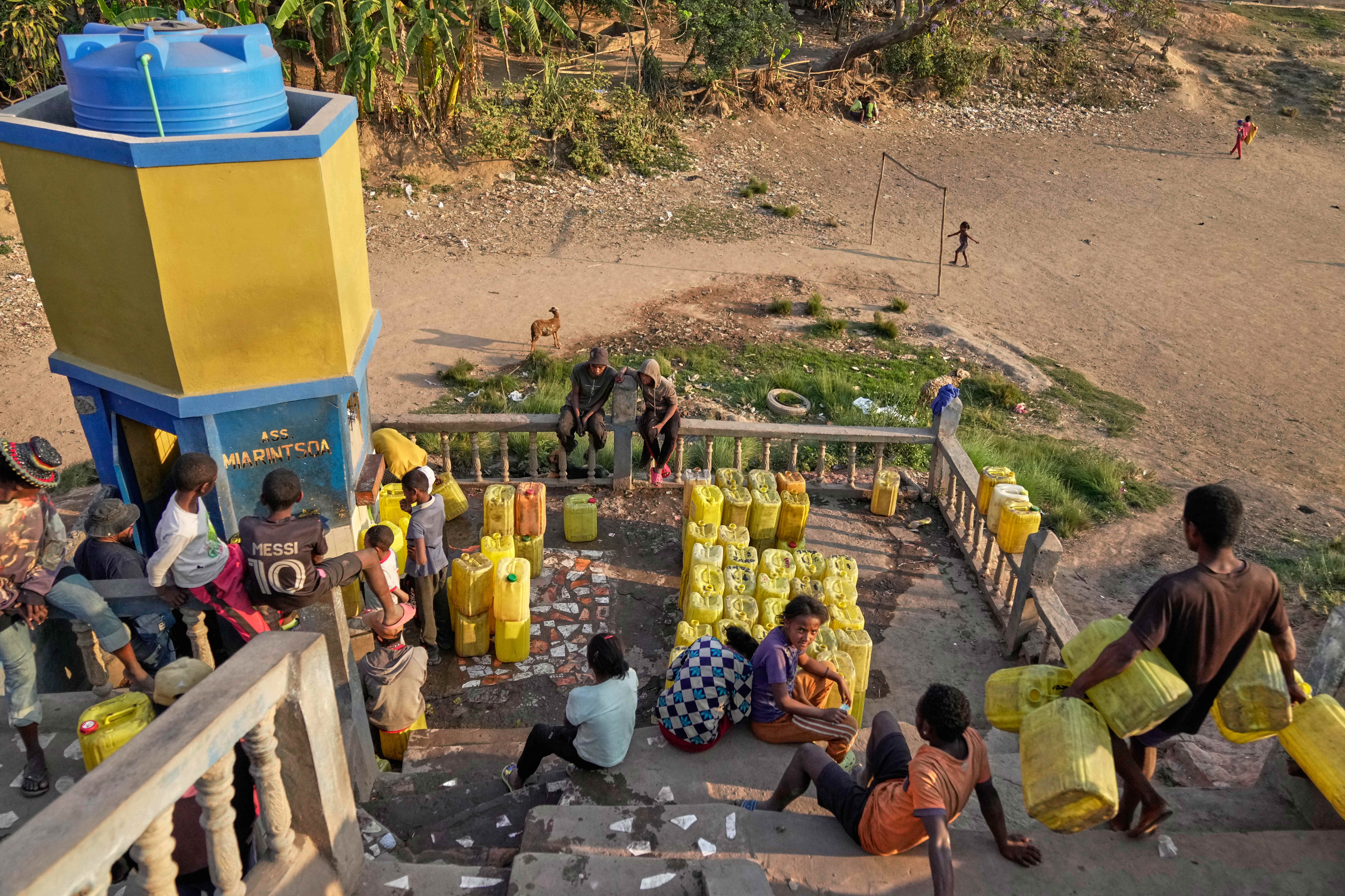Residents gather water from a storage tank vendor in the Anosimahavelona informal settlement in Antananarivo, Madagascar, Thursday, Oct. 16, 2025. (AP Photo/Brian Inganga)