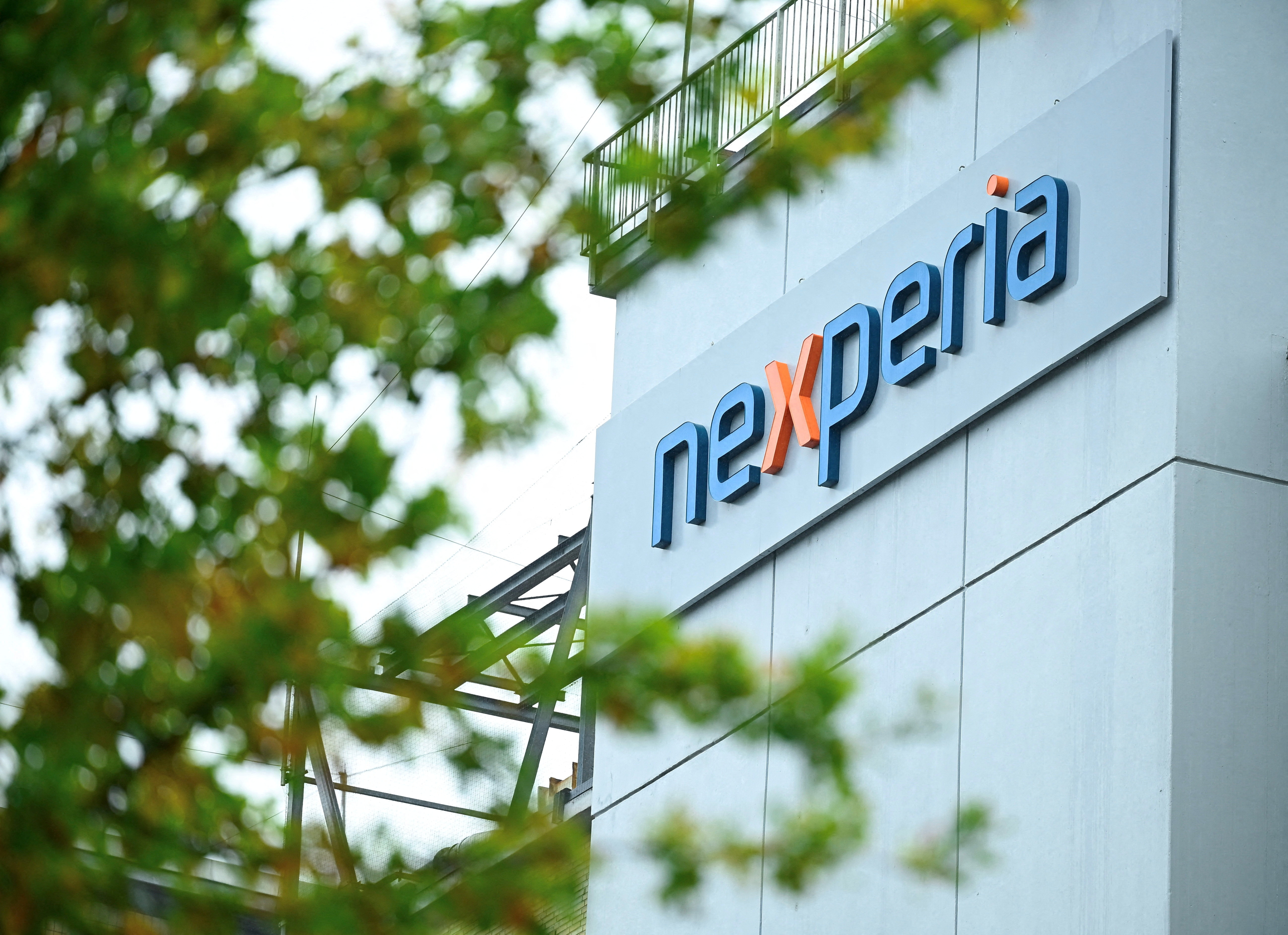 FILE PHOTO: The logo of Chinese-owned semiconductor company Nexperia is displayed at the chipmaker's German facility, after the Dutch government seized control and auto industry bodies sounded the alarm over the possible impact on car production, in Hamburg, Germany, October 23, 2025. REUTERS/Jonas Walzberg/File Photo