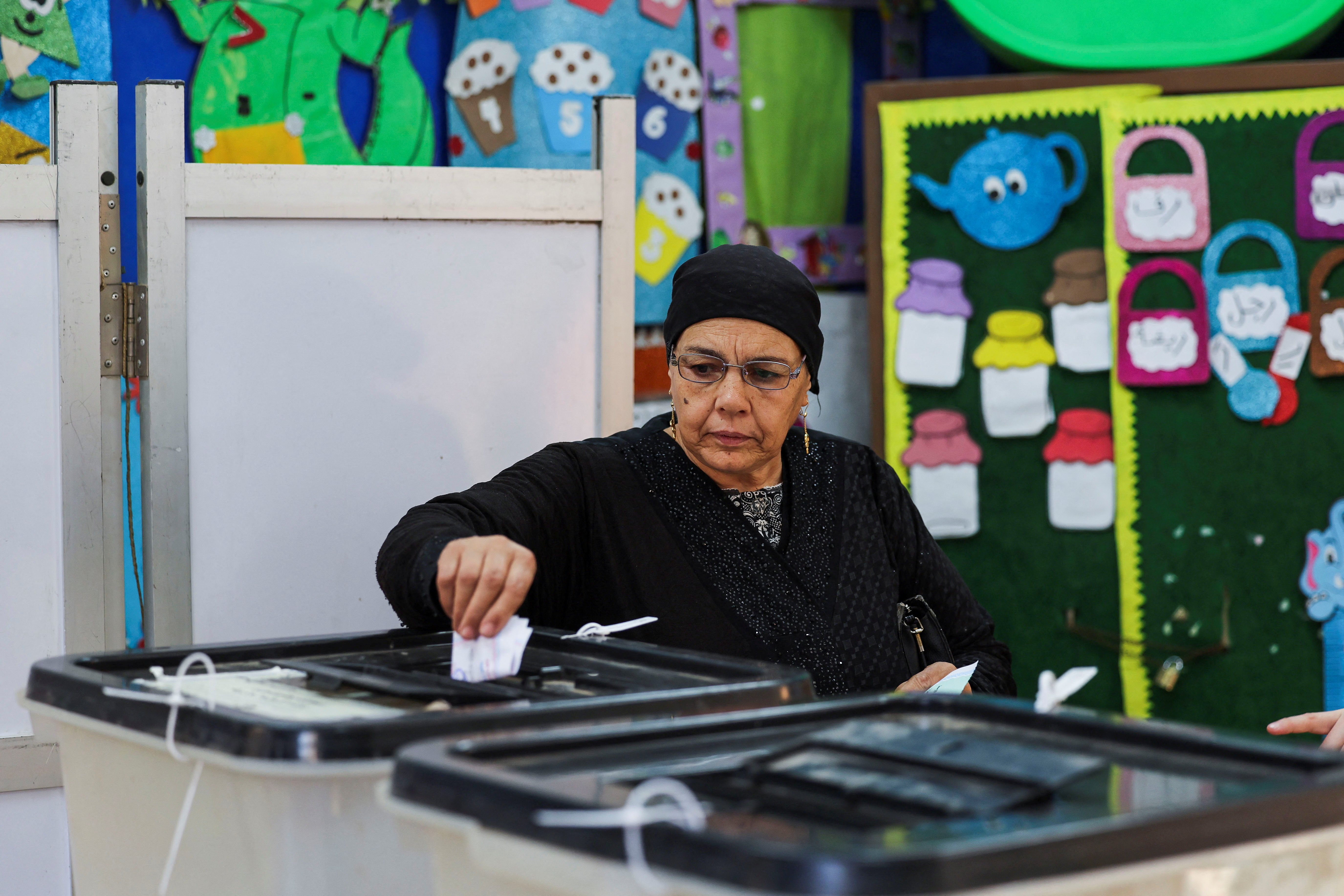 A woman votes at a school used as a polling station, during the first round of Egypt's parliamentary elections, in Giza, Egypt, November 10, 2025. REUTERS/Mohamed Abd El Ghany