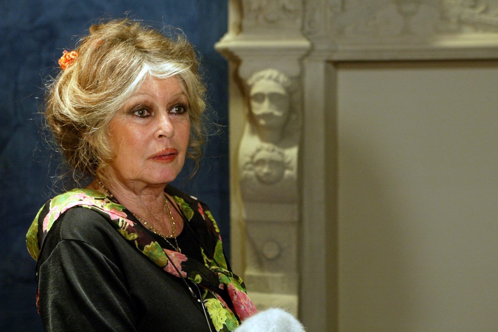 French actress and animal rights activist Brigitte Bardot poses in an office of the French National Assembly in Paris after a conference criticizing the transport of live animals to the slaughterhouse [Jack Guez/AFP]