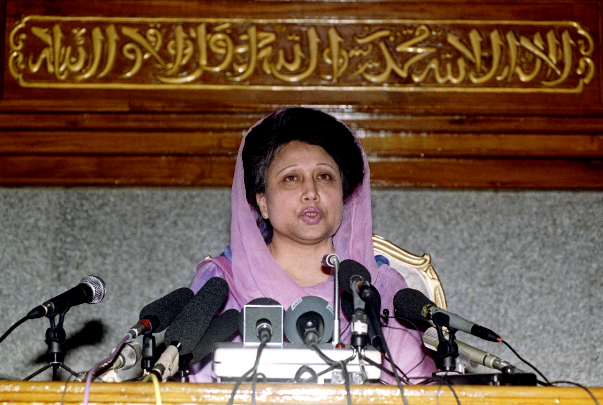 Bangladesh Prime Minister Begum Khaleda Zia speaks to reporters from below an Islamic inscription in Arabic reads "God is one and Mohamad is his prophet" February 13 in Dhaka. Khaleda Zia is pushing through with her plans to hold a general election on February 15 despite the withdrawal of all major opposition parties from the contest