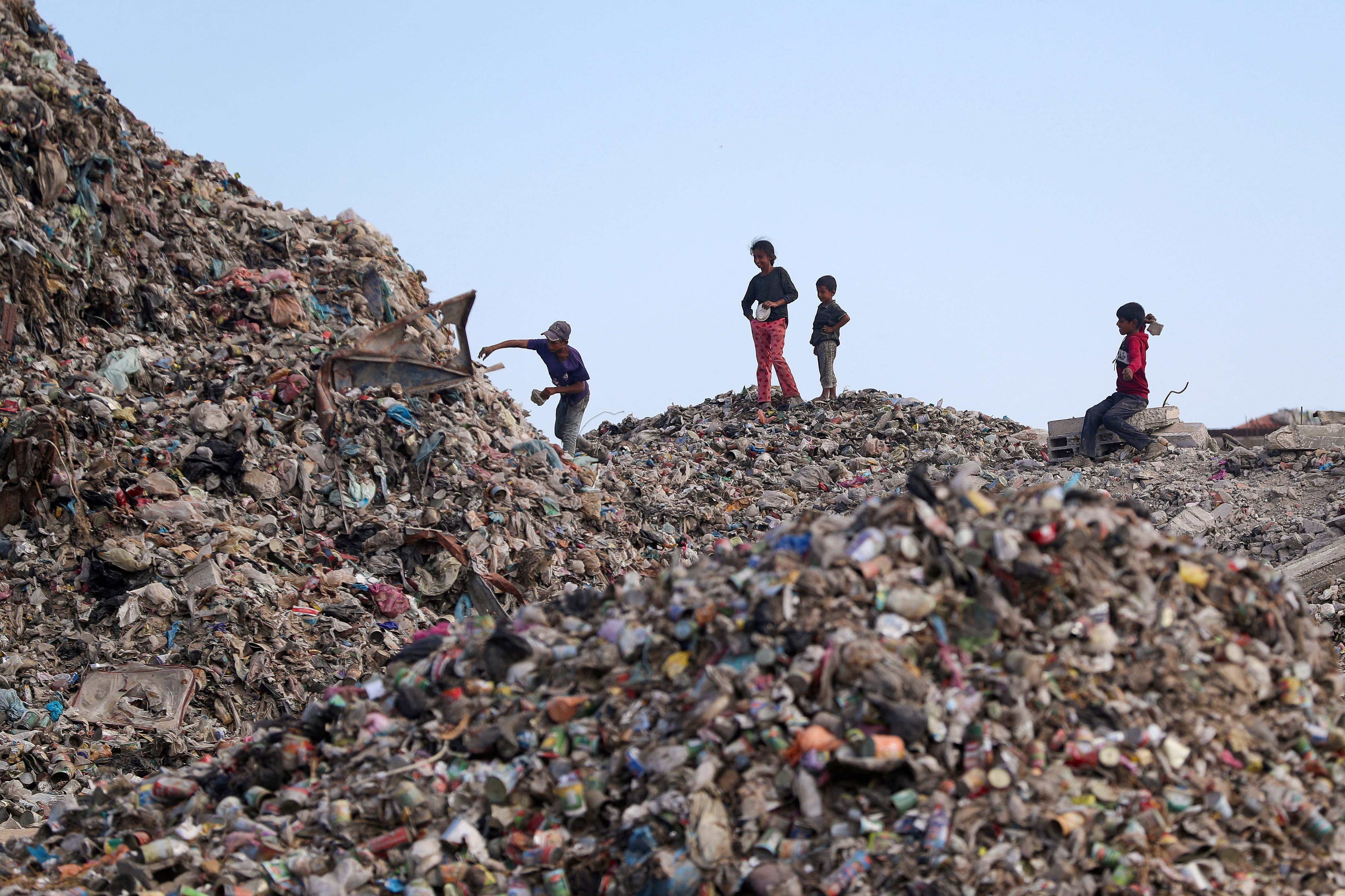 Palestinian children search for useable items at a dump site.
