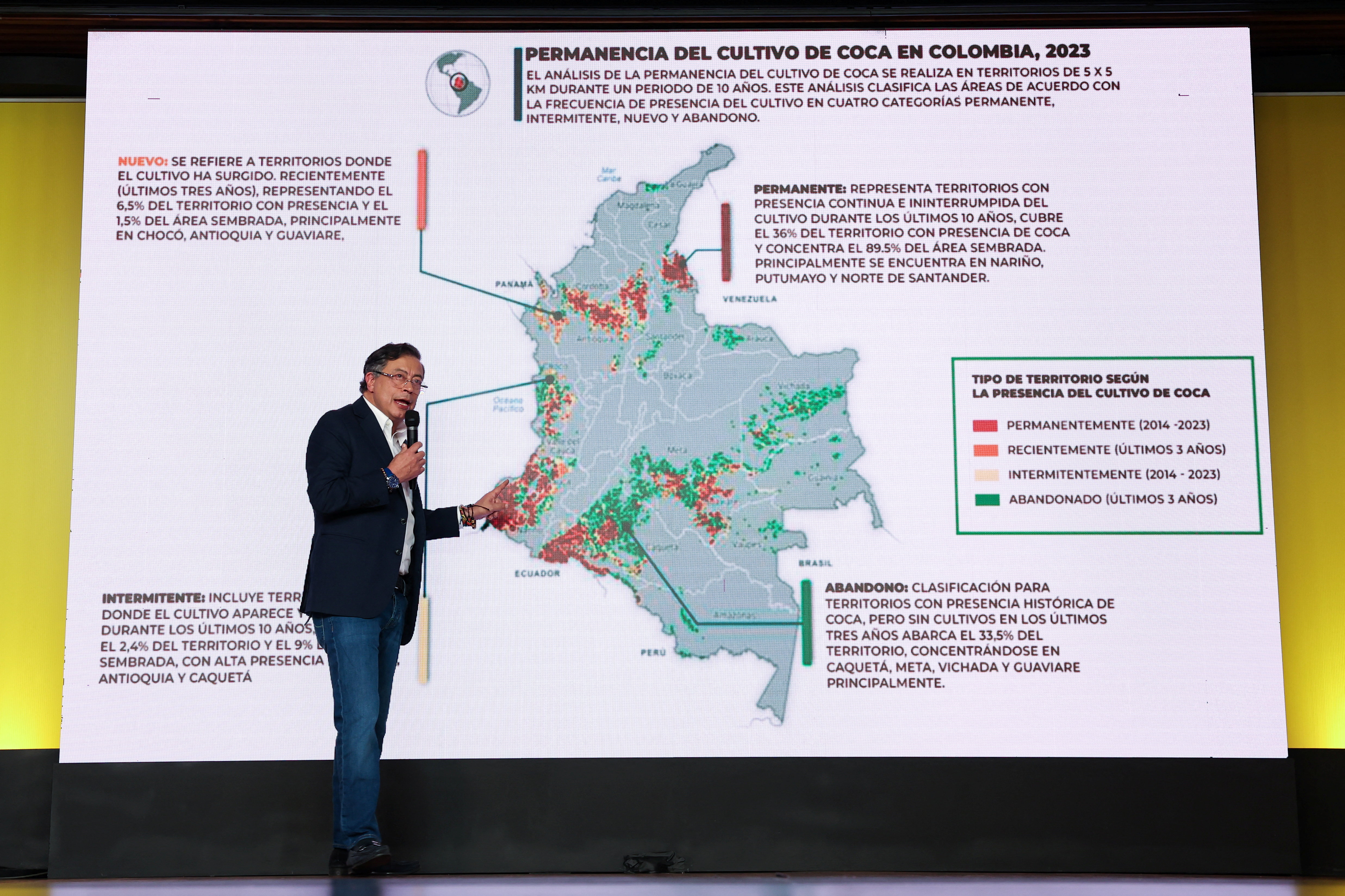 Gustavo Petro stands in front of a map of cocaine production in Colombia