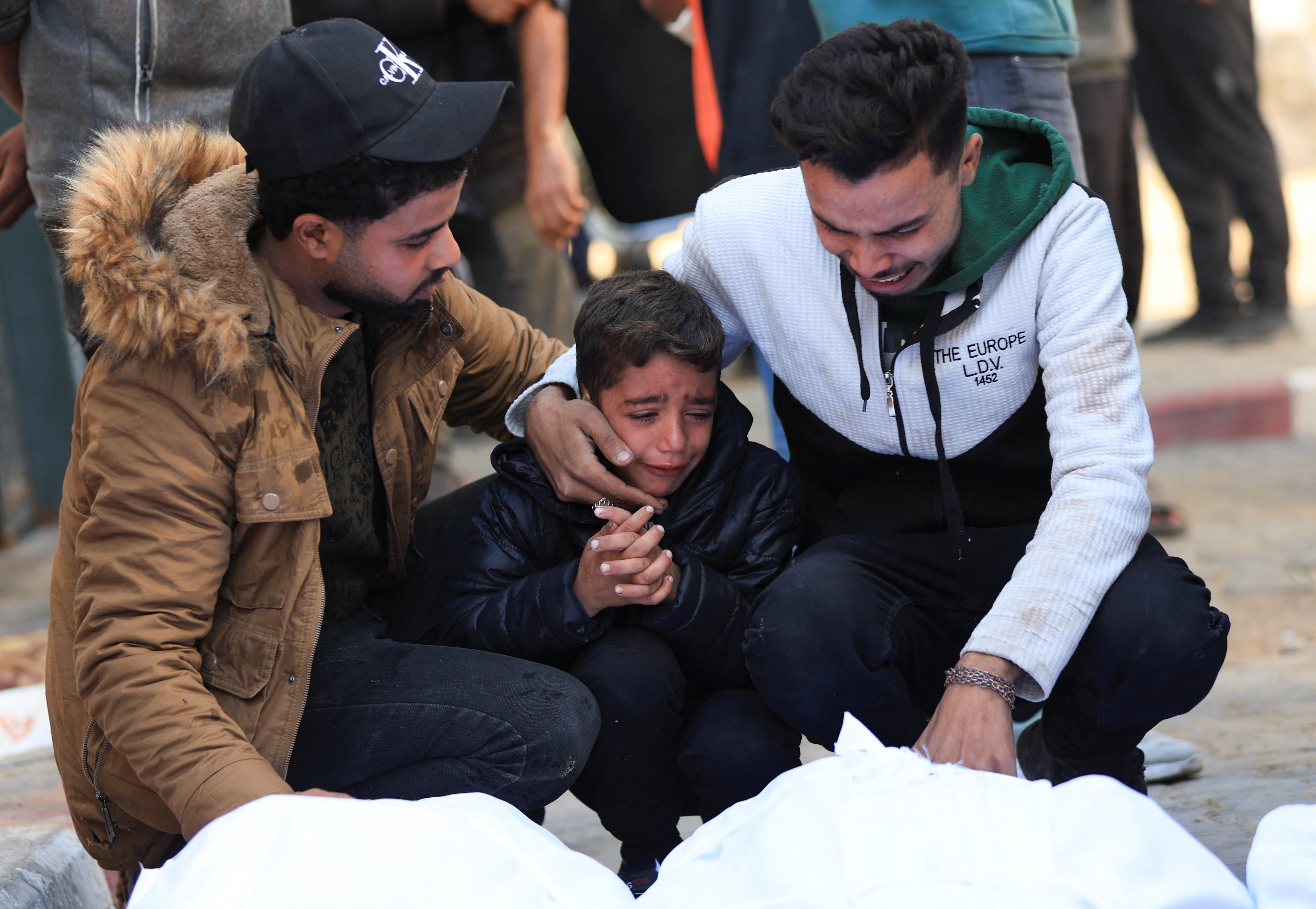 Mourners react as they attend the funeral of Palestinians who, according to medics, were killed in an Israeli strike on Tuesday, at Al-Shifa Hospital in Gaza City, December 3, 2025.