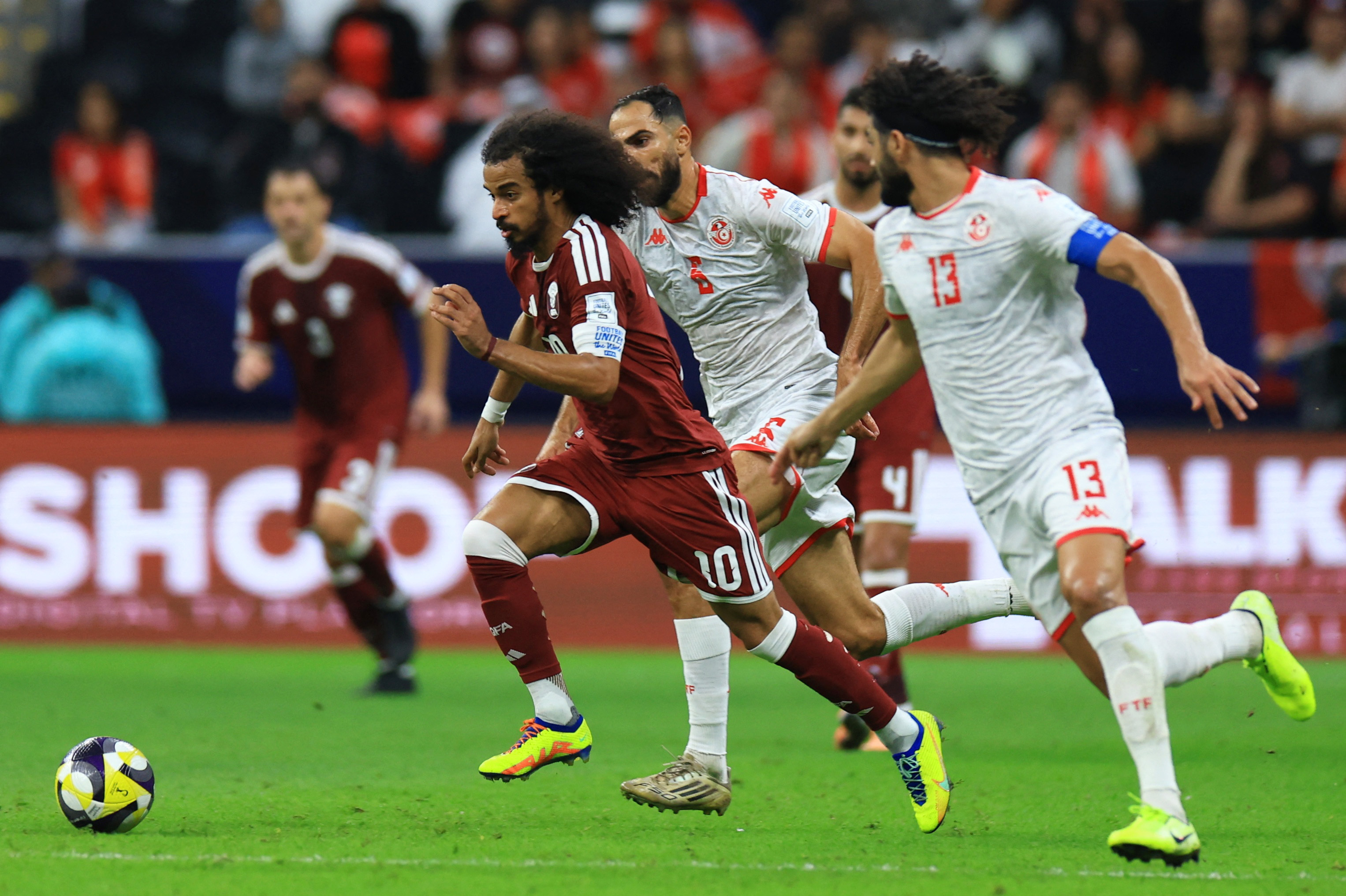 Soccer Football - FIFA Arab Cup - Qatar 2025 - Group A - Qatar v Tunisia - Al Bayt Stadium, Al Khor, Qatar - December 7, 2025 Qatar's Akram Afif in action with Tunisia's Ferjani Sassi REUTERS/Thaier Al-Sudani