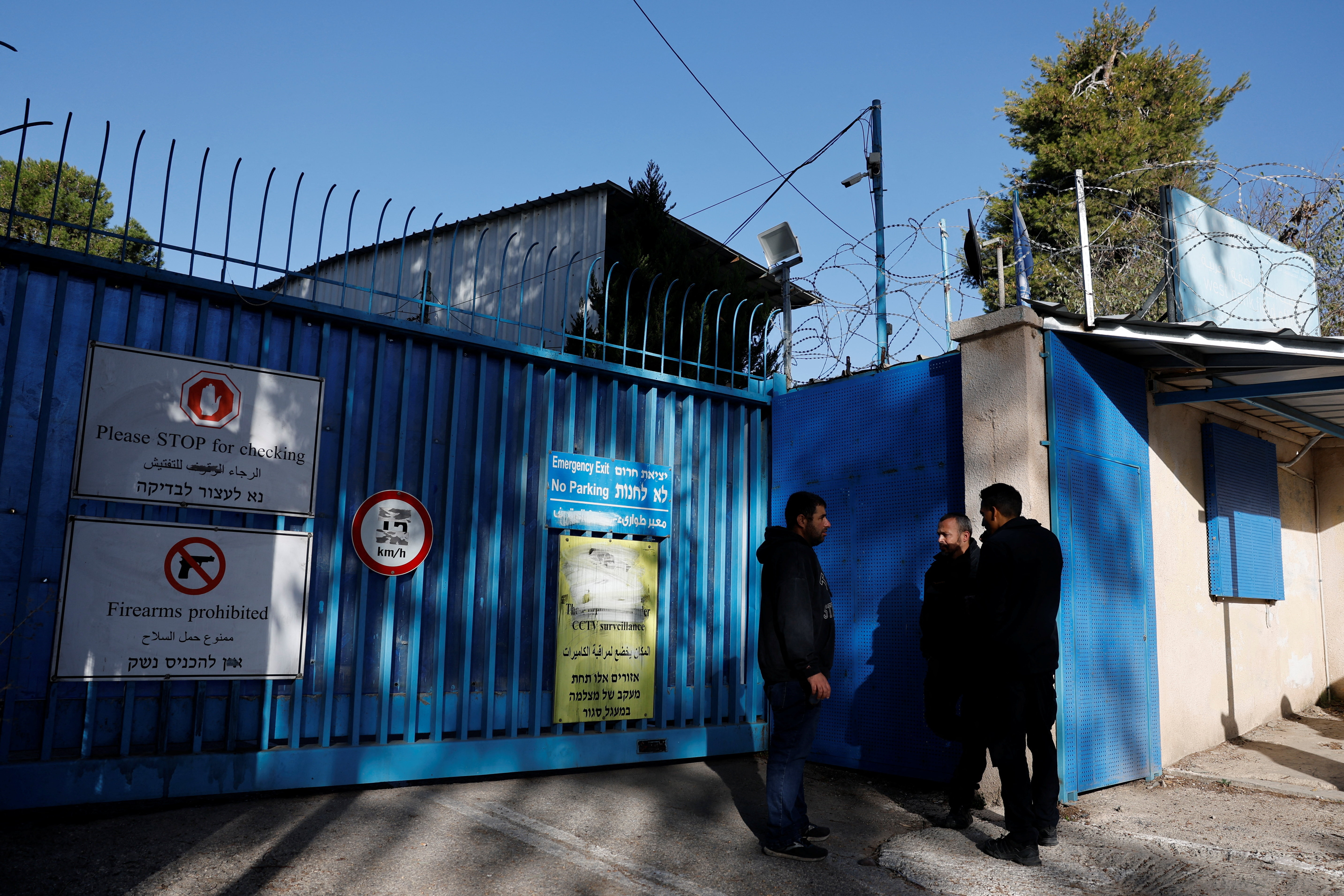Israeli police officers wait outside the United Nations Relief and Works Agency for Palestine Refugees