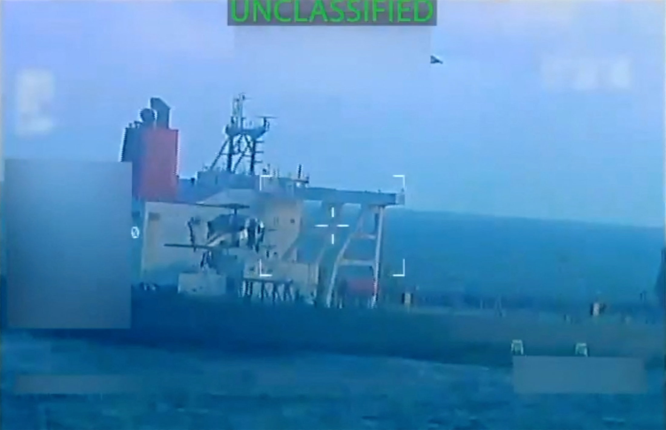 A US military helicopter flies near an oil tanker during a seizure by the United States off the coast of Venezuela, on December 10, 2025, in a still image from video