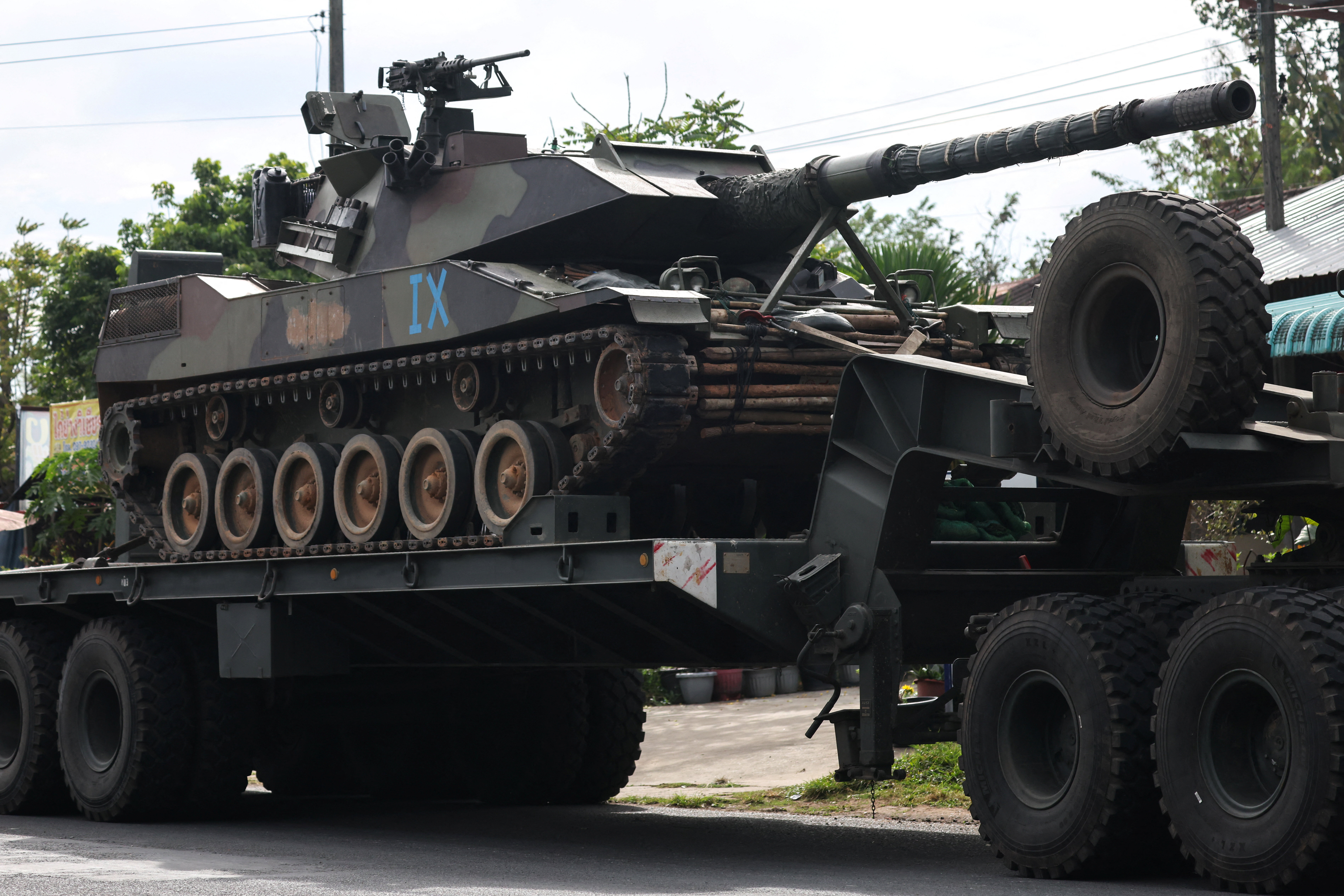 A military truck carries a tank on a road amid deadly clashes between Thailand and Cambodia along a disputed border area, in Surin province, Thailand, December 11, 2025. REUTERS/Athit Perawongmetha