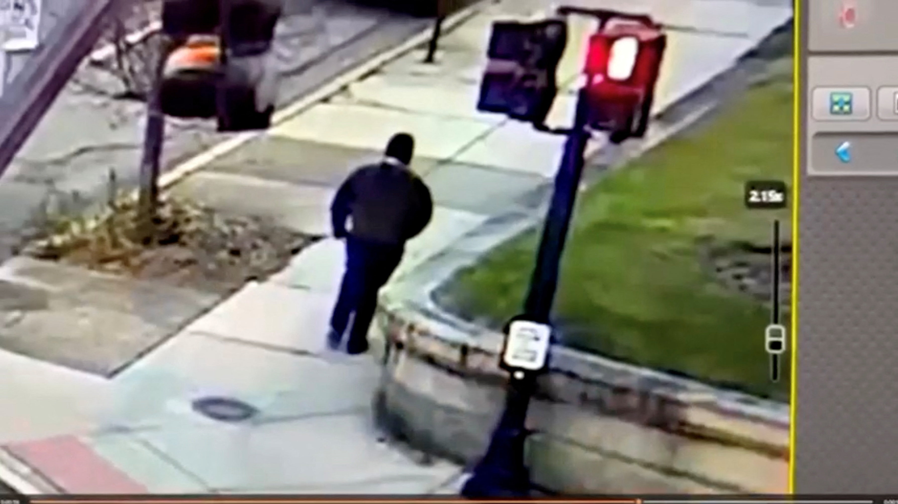 A monitor shows security camera footage of who police say is the Brown University shooting suspect leaving the scene.