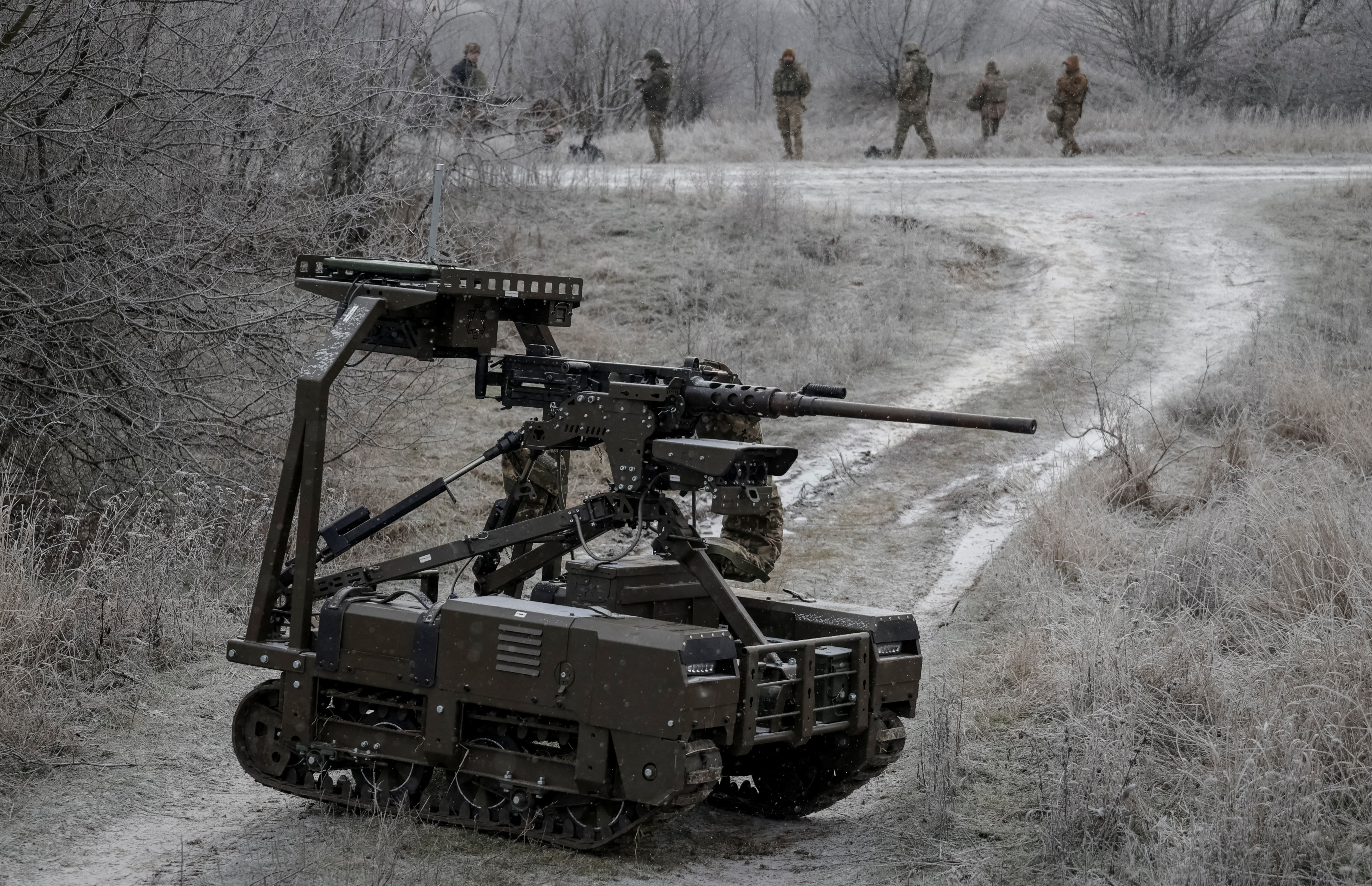 Servicemen of the 66th Separate Mechanized Brigade of the Ukrainian Armed Forces test an unmanned ground vehicle with Browning M2 machine gun installed on it, amid Russia's attack on Ukraine, in Kharkiv region, Ukraine, December 15, 2025. REUTERS/Sofia Gatilova
