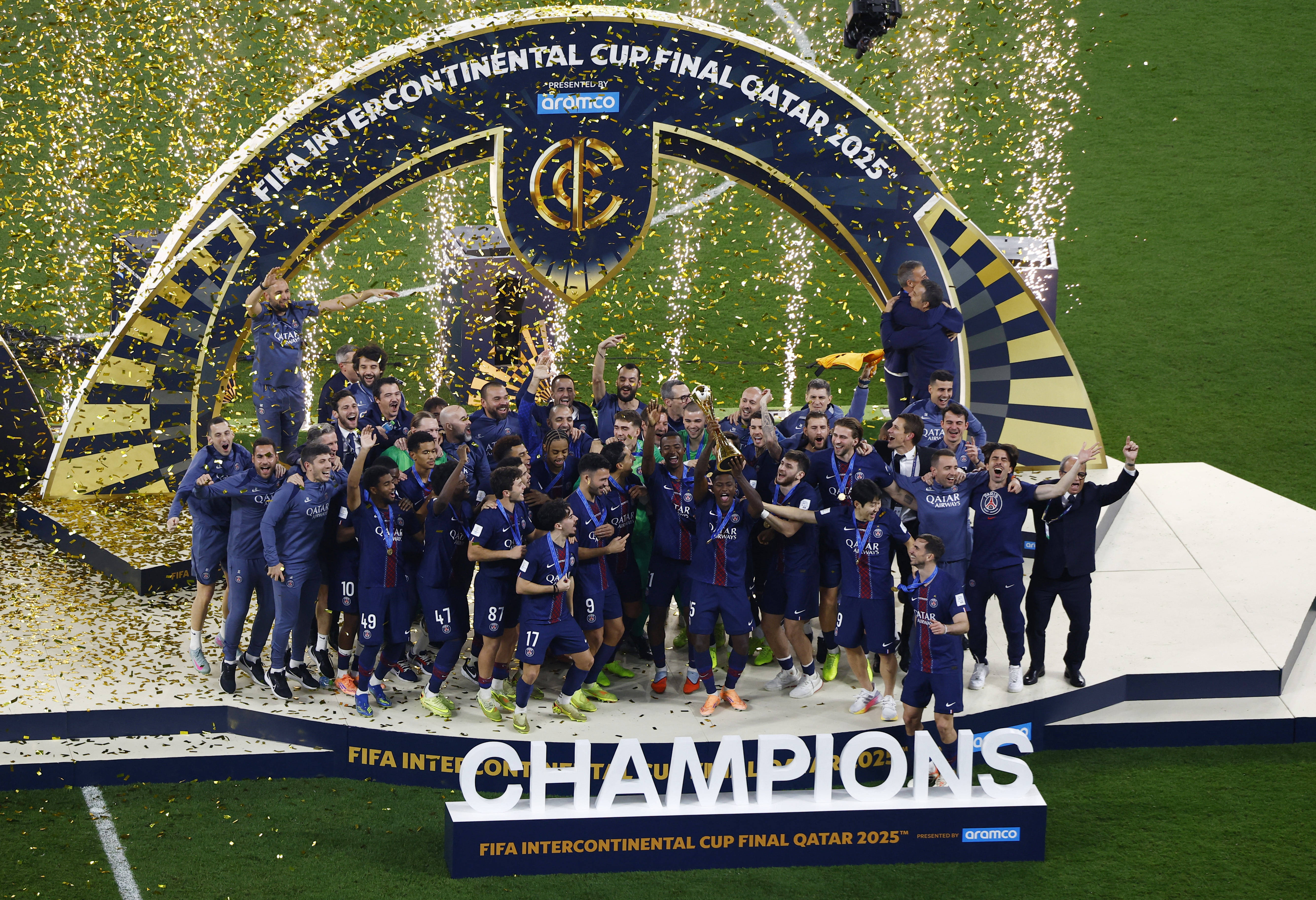 Paris St Germain's Nuno Mendes lifts the trophy with teammates after winning the FIFA Intercontinental cup final