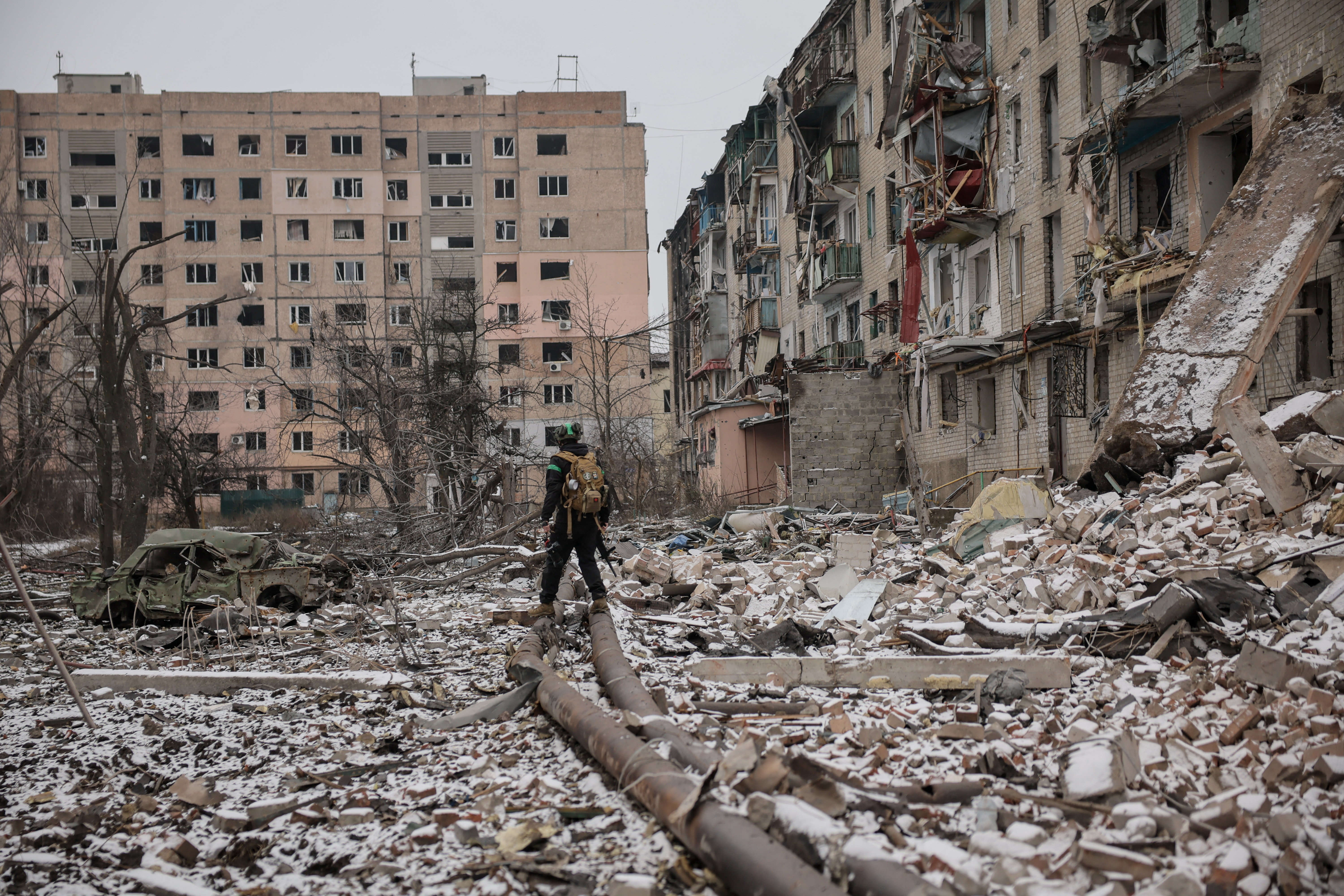 Ukrainian serviceman walks near apartment buildings damaged by Russian military strike, amid Russia's attack on Ukraine, in the frontline town of Kostiantynivka in Donetsk region, Ukraine December 18, 2025. Oleg Petrasiuk/Press Service of the 24th King Danylo Separate Mechanized Brigade of the Ukrainian Armed Forces/Handout via REUTERS ATTENTION EDITORS - THIS IMAGE HAS BEEN SUPPLIED BY A THIRD PARTY.