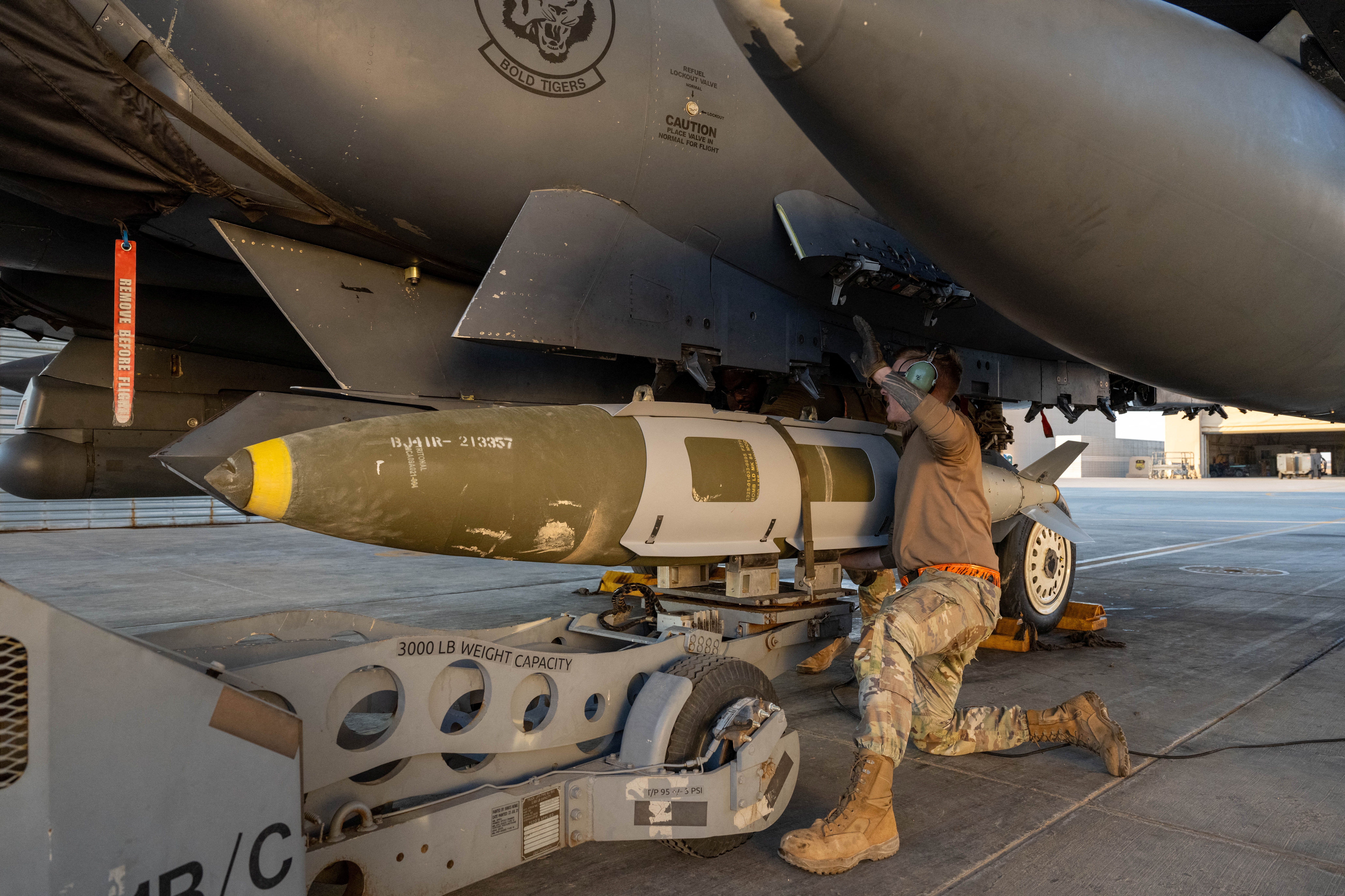 A U.S. Airman attaches a GBU-31 munitions system to an F-15E Strike Eagle in the U.S. Central Command area of responsibility, December 19, 2025, in support of Operation Hawkeye Strike as the U.S. military launched large-scale strikes against dozens of Islamic State targets in Syria in retaliation for an attack on U.S. personnel, U.S. officials said. U.S. Air Force Photo/Handout via REUTERS THIS IMAGE HAS BEEN SUPPLIED BY A THIRD PARTY